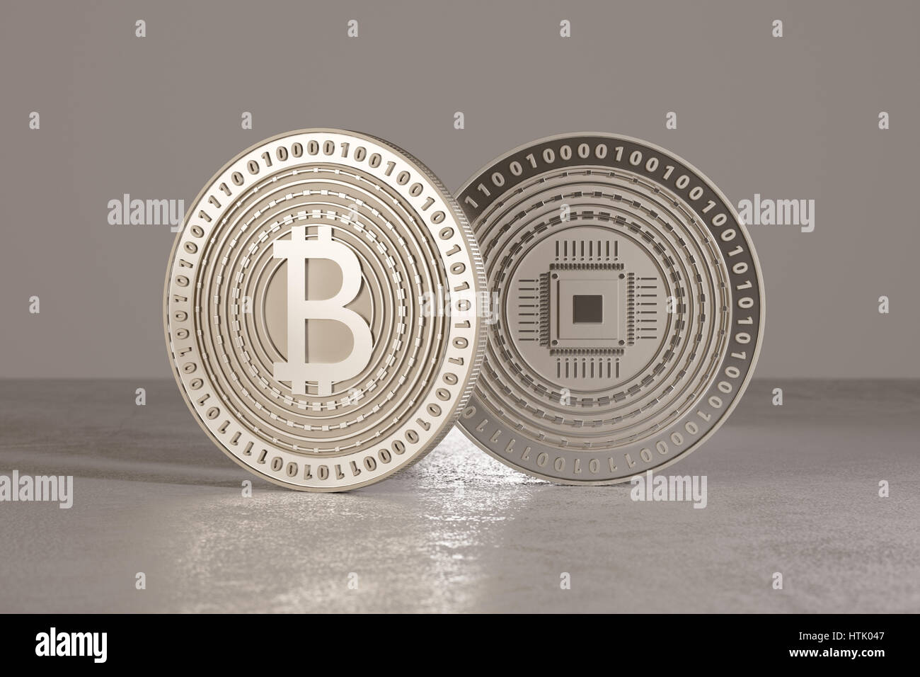 Close-up of two bitcoins standing on metal floor and blurry background Stock Photo