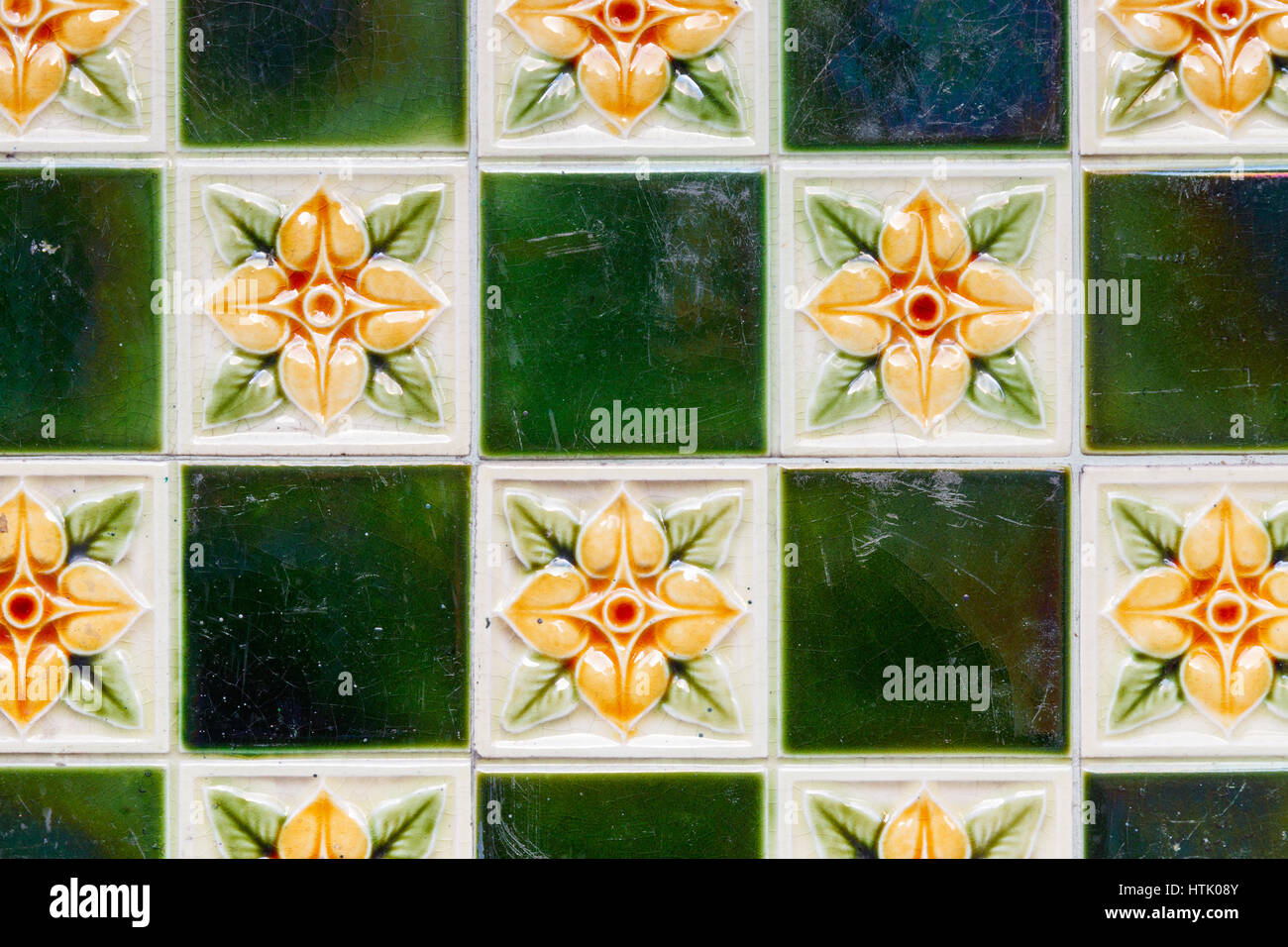 Pattern with green colored tiles and tiles with a flower. Stock Photo