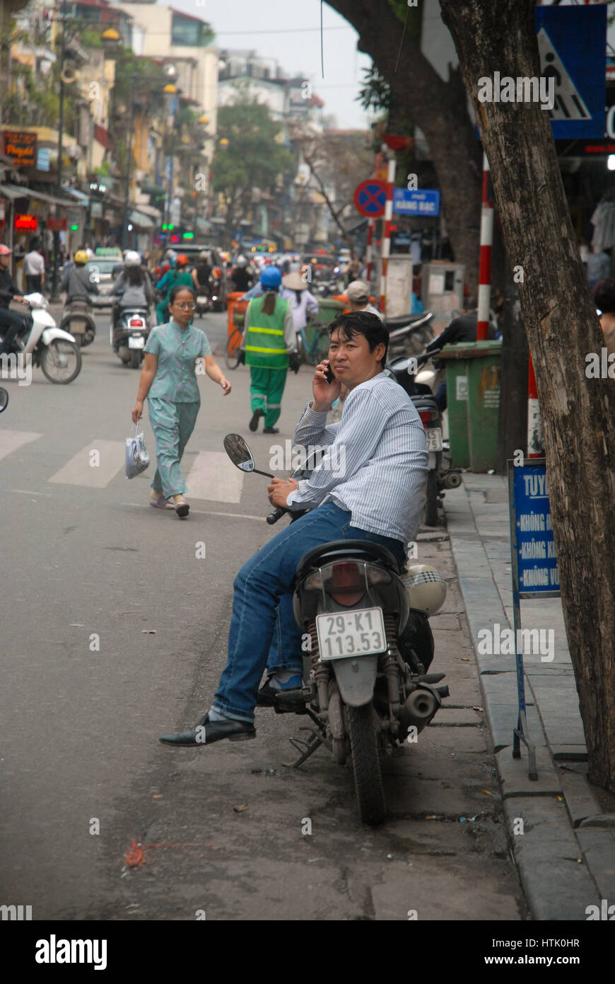 People in the street on their motorbikes, Hanoi, Vietnam. Stock Photo