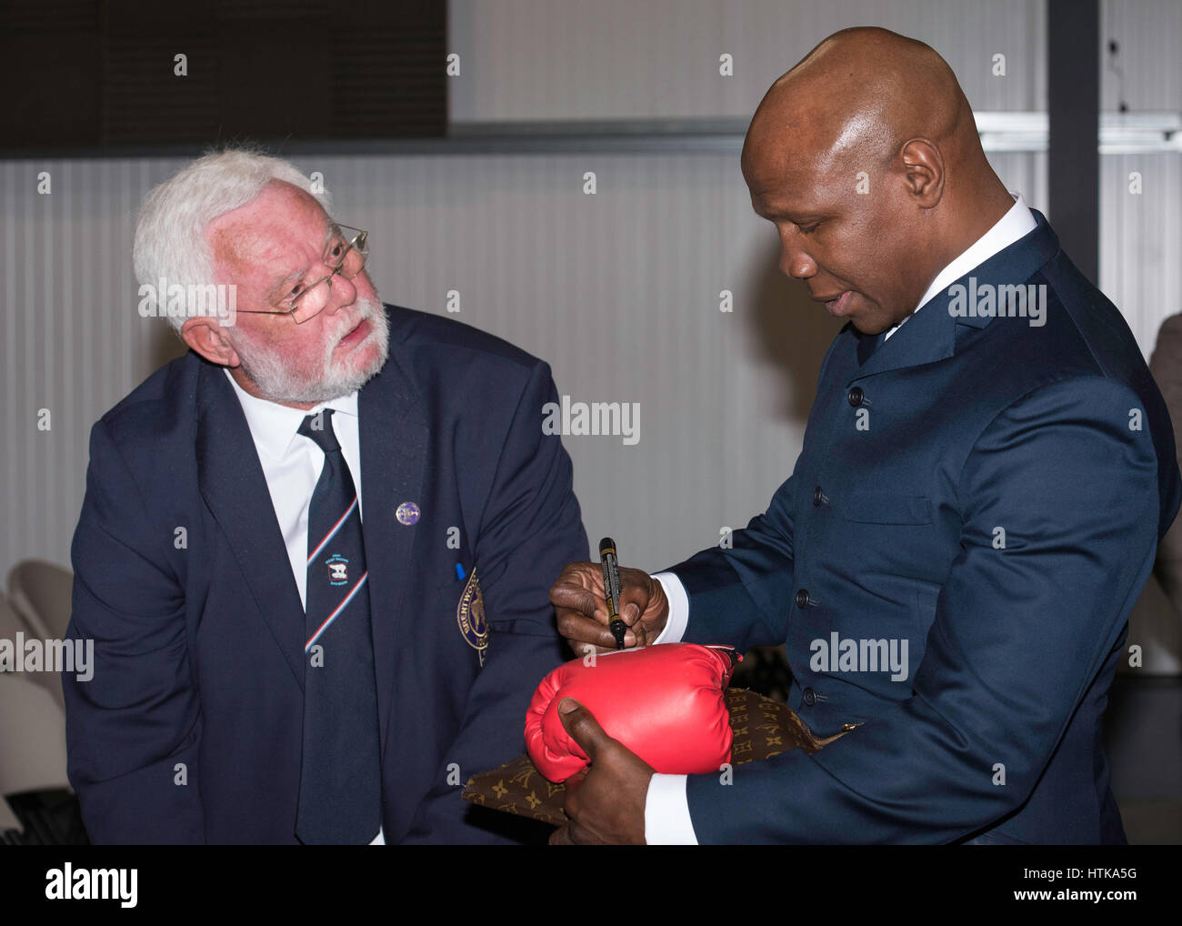 Brentwood, 12th March 2017; Chris Eubank, Former World boxing Champion, signs boxing gloves at a youth concert in Brentwood, Essex Credit: Ian Davidson/Alamy Live News Stock Photo