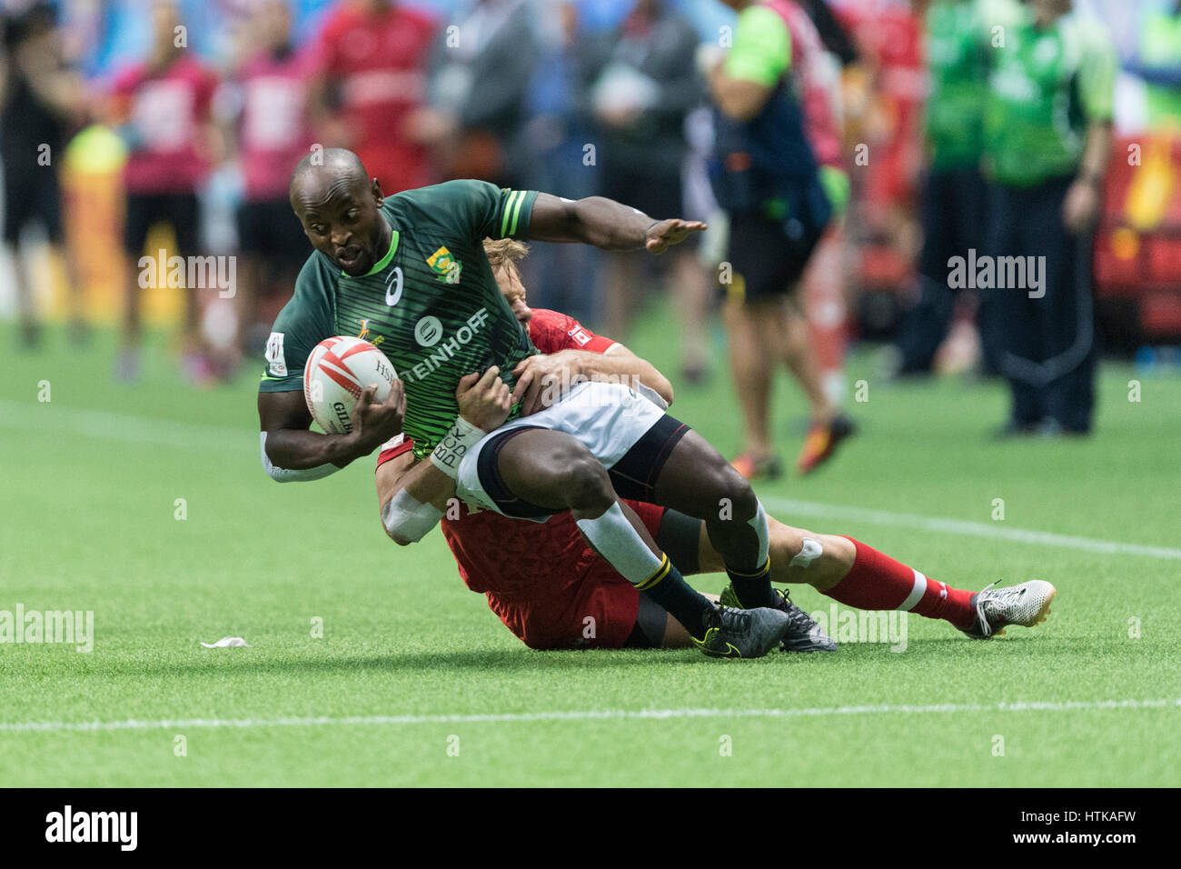 Vancouver, Canada. 12th Mar, 2017. Harry Jones (11) of Canada takes Sandile Ngcobo (8) of South Africa. Day 2-Cup Quarter Final- HSBC Canada Sevens Rugby, BC Place Stadium. South Africa defeats Canada 36-7. Credit: Gerry Rousseau/Alamy Live News Stock Photo