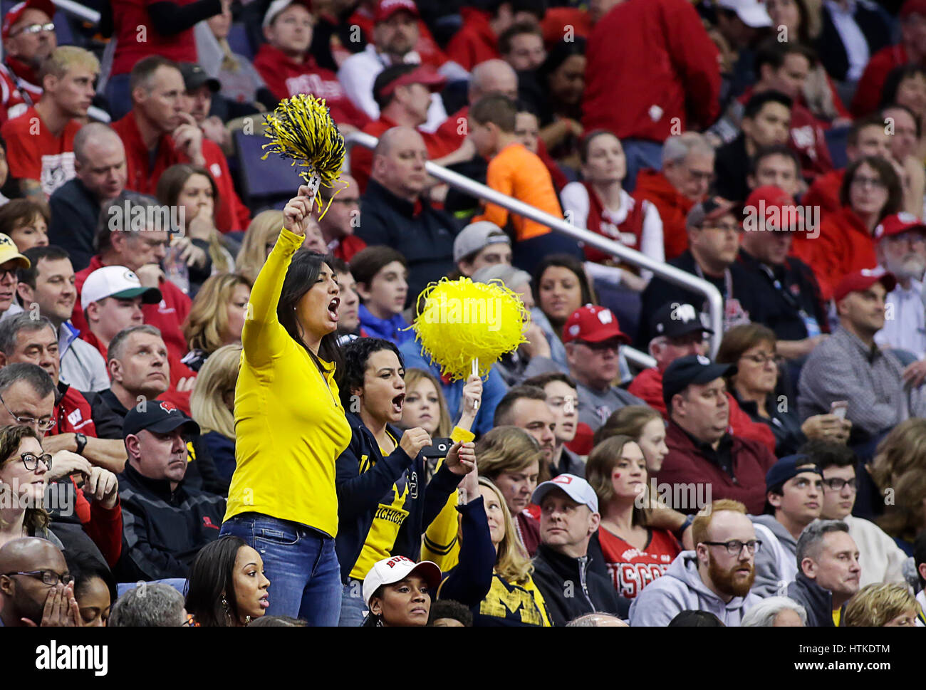 Washington, DC, USA. 12th Mar, 2017. Michigan fans cheer on their team in a sea of red during the Big 10 Men's Basketball Tournament championship game between the Wisconsin Badgers and the Michigan Wolverines at the Verizon Center in Washington, DC. Michigan wins the Big Ten Tournament defeating Wisconsin, 71-56. Justin Cooper/CSM/Alamy Live News Stock Photo