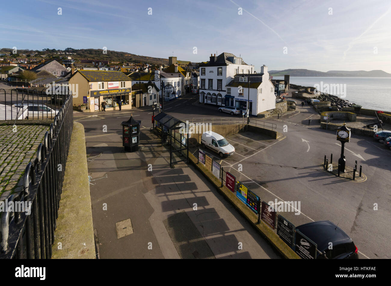 Lyme Regis, Dorset, UK.  13th March 2017.  UK Weather. Beautiful warm spring sunshine and blues skies during the morning at the seaside resort of Lyme Regis on the Dorset Jurassic Coast.  The view is of Cobb Gate at the bottom of Broad Street.  Photo by Graham Hunt/Alamy Live News Stock Photo