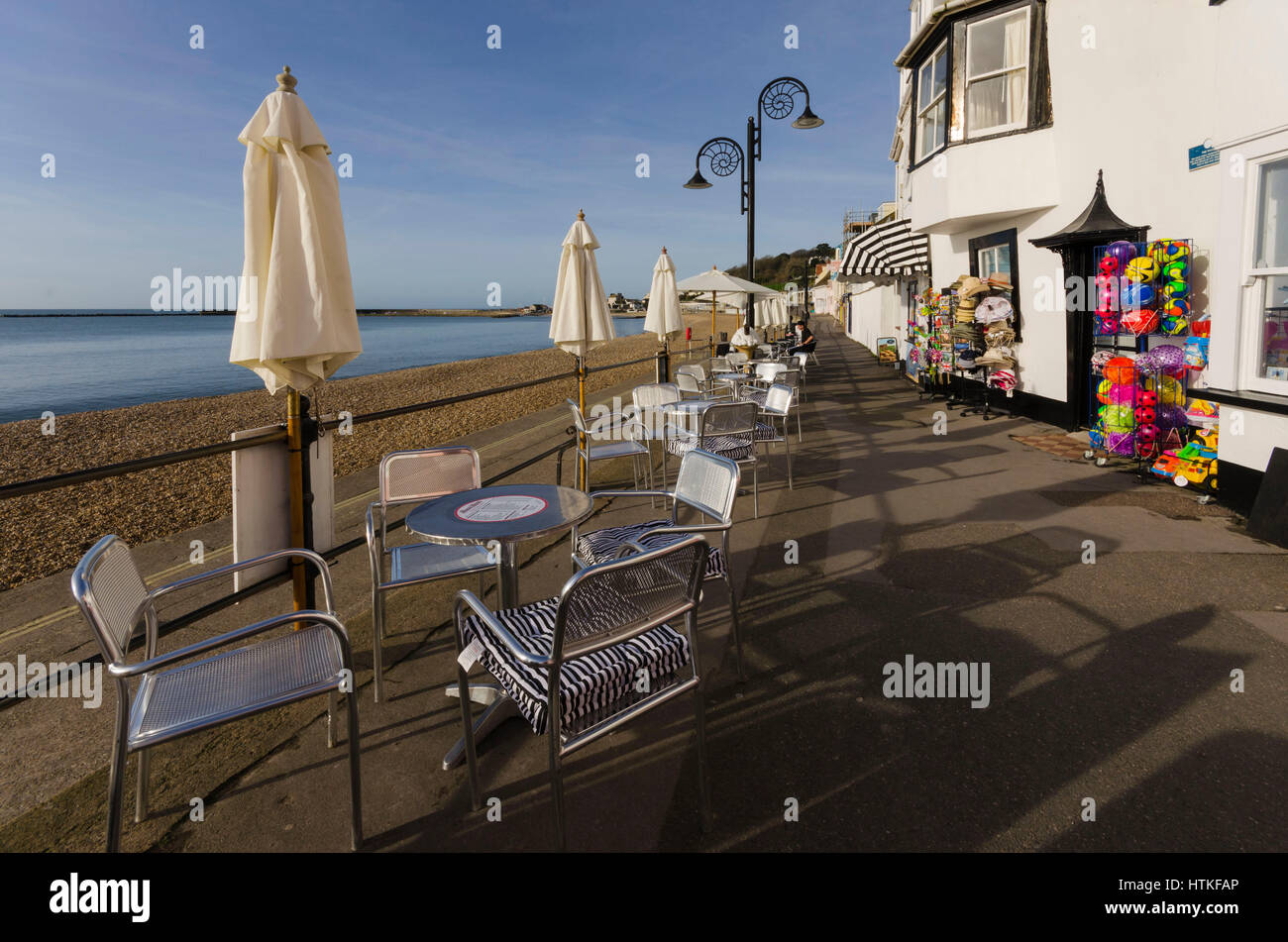 Lyme Regis, Dorset, UK.  13th March 2017.  UK Weather. Tables ready for customers. Beautiful warm spring sunshine and blues skies during the morning at the seaside resort of Lyme Regis on the Dorset Jurassic Coast.  Photo by Graham Hunt/Alamy Live News Stock Photo