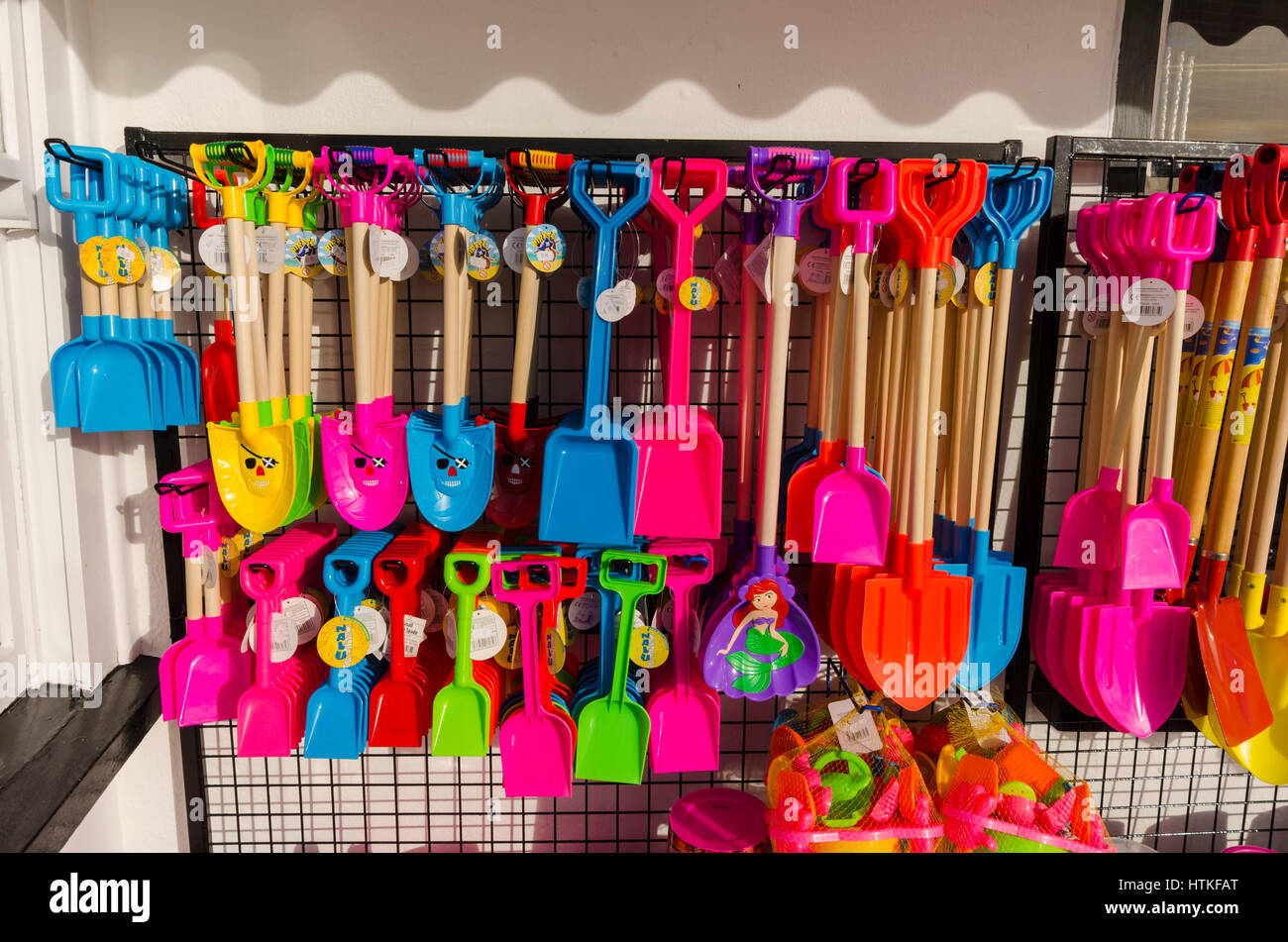 Lyme Regis, Dorset, UK.  13th March 2017.  UK Weather. Buckets and spades displayed outside a seafront shop on a beautiful warm spring sunny morning at the seaside resort of Lyme Regis on the Dorset Jurassic Coast.  Photo by Graham Hunt/Alamy Live News Stock Photo