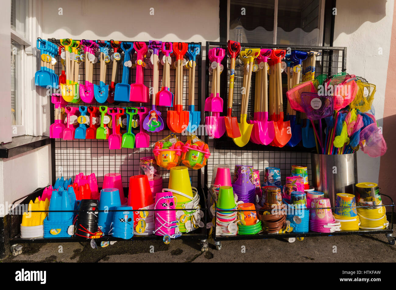Lyme Regis, Dorset, UK.  13th March 2017.  UK Weather. Buckets and spades displayed outside a seafront shop on a beautiful warm spring sunny morning at the seaside resort of Lyme Regis on the Dorset Jurassic Coast.  Photo by Graham Hunt/Alamy Live News Stock Photo