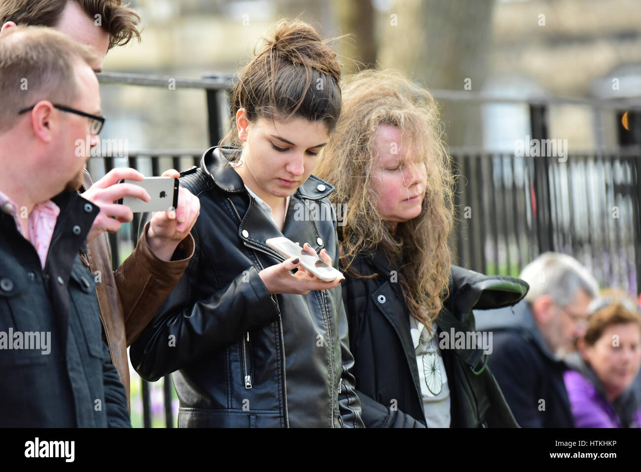 Edinburgh, Scotland, UK. 13th Mar, 2017. A small group of onlookers outside Bute House, the official residence of Scotland's First Minister Nicola Sturgeon, use their phones to follow Ms Sturgeon's announcement inside that she intends to seek Scottish Parliament and UK Government approval to call a second referendum on Scottish independence, Credit: Ken Jack/Alamy Live News Stock Photo