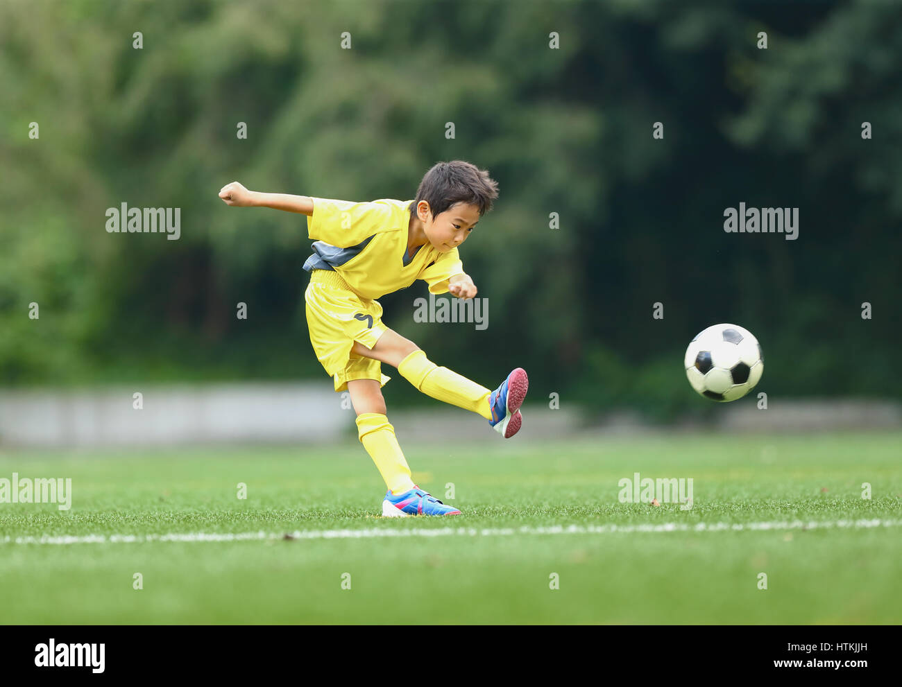 Japanese kid playing soccer Stock Photo