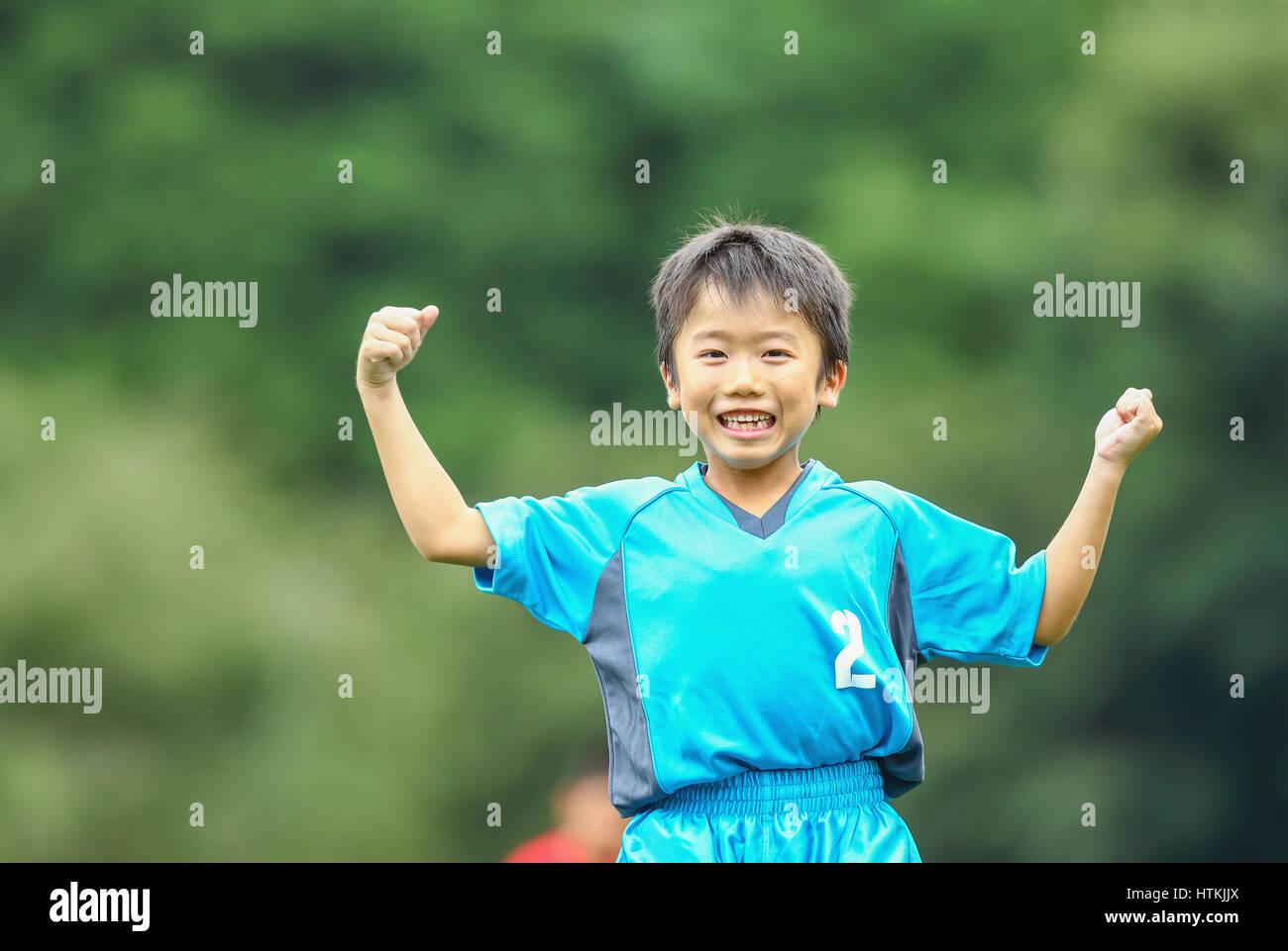 Japanese kid playing soccer Stock Photo