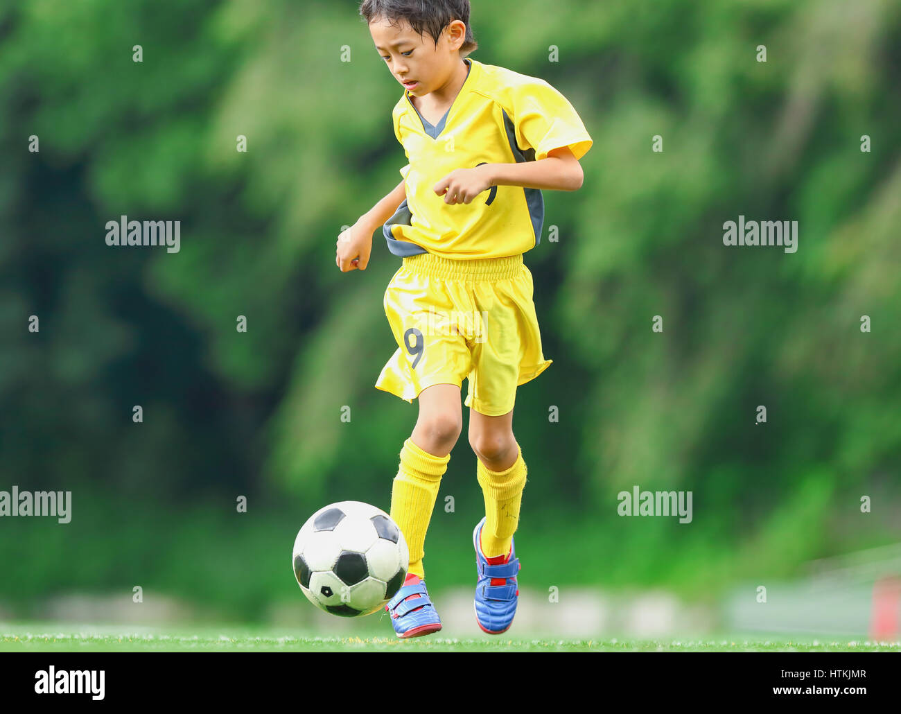 Japanese kid playing soccer Stock Photo Alamy