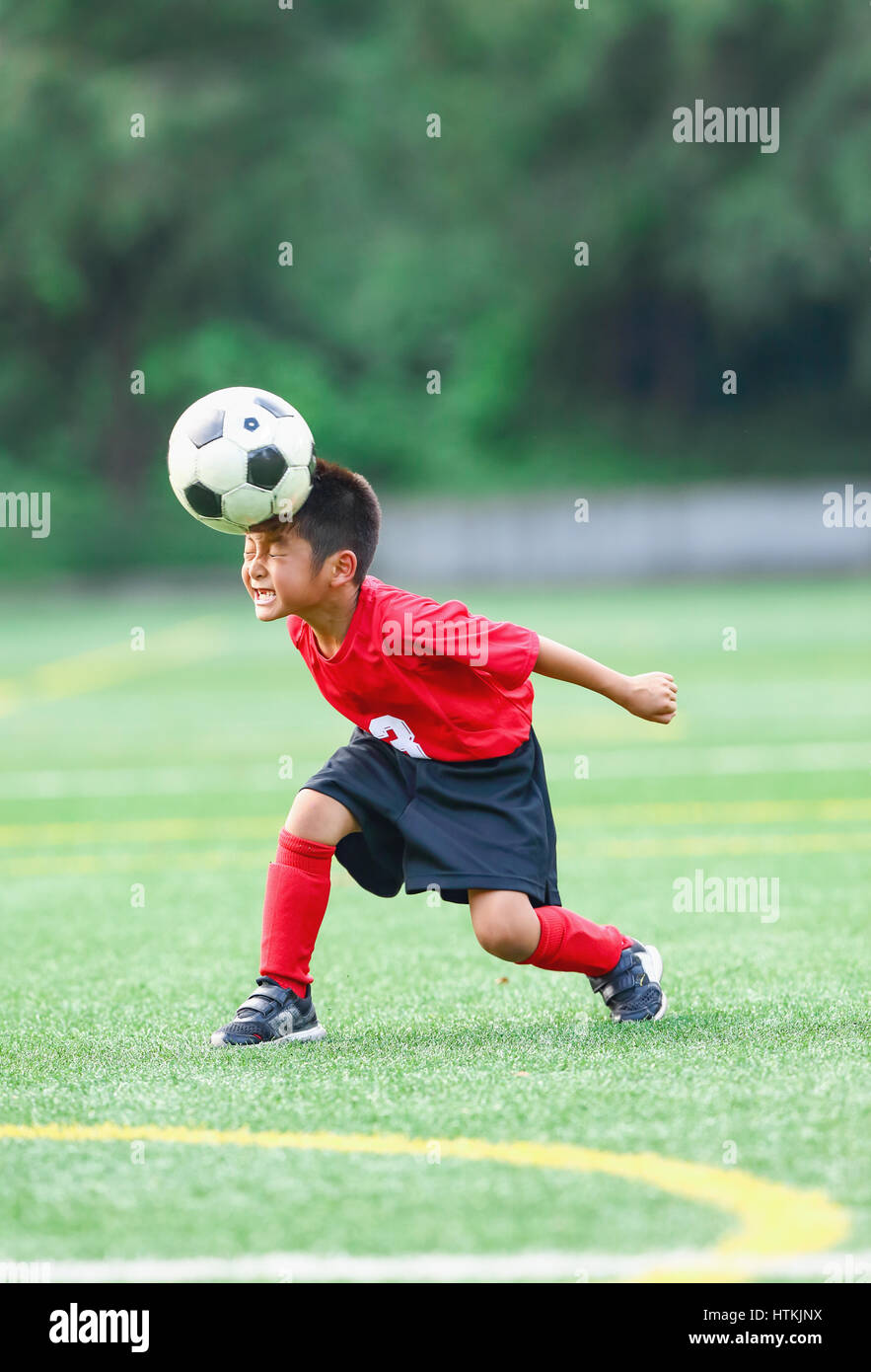 Japanese kid playing soccer Stock Photo Alamy
