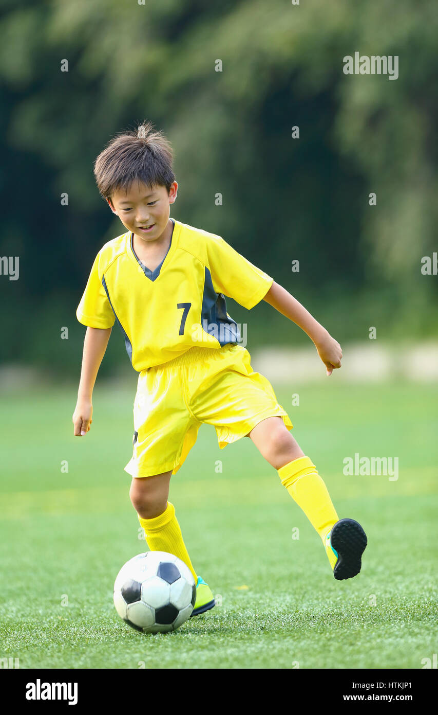Japanese kid playing soccer Stock Photo Alamy
