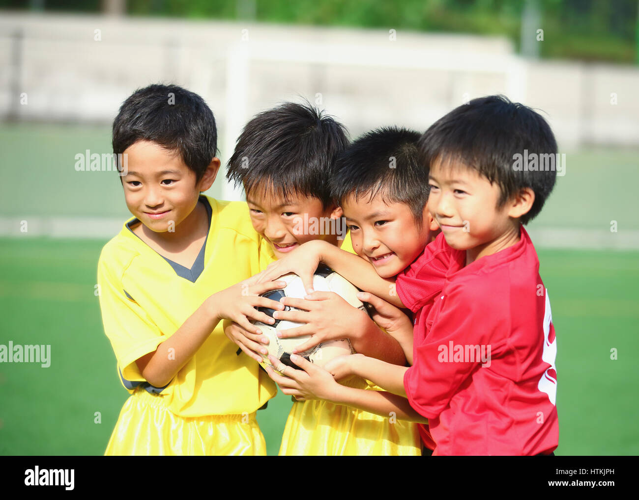 Japanese kids playing soccer Stock Photo