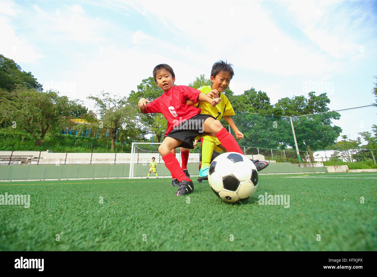 Japanese kids playing soccer Stock Photo