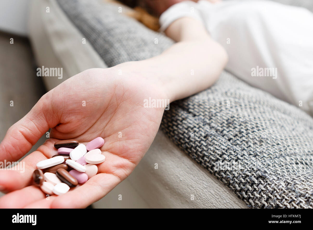 dead woman lie on sofa after she eat drugs or pills, addiction on