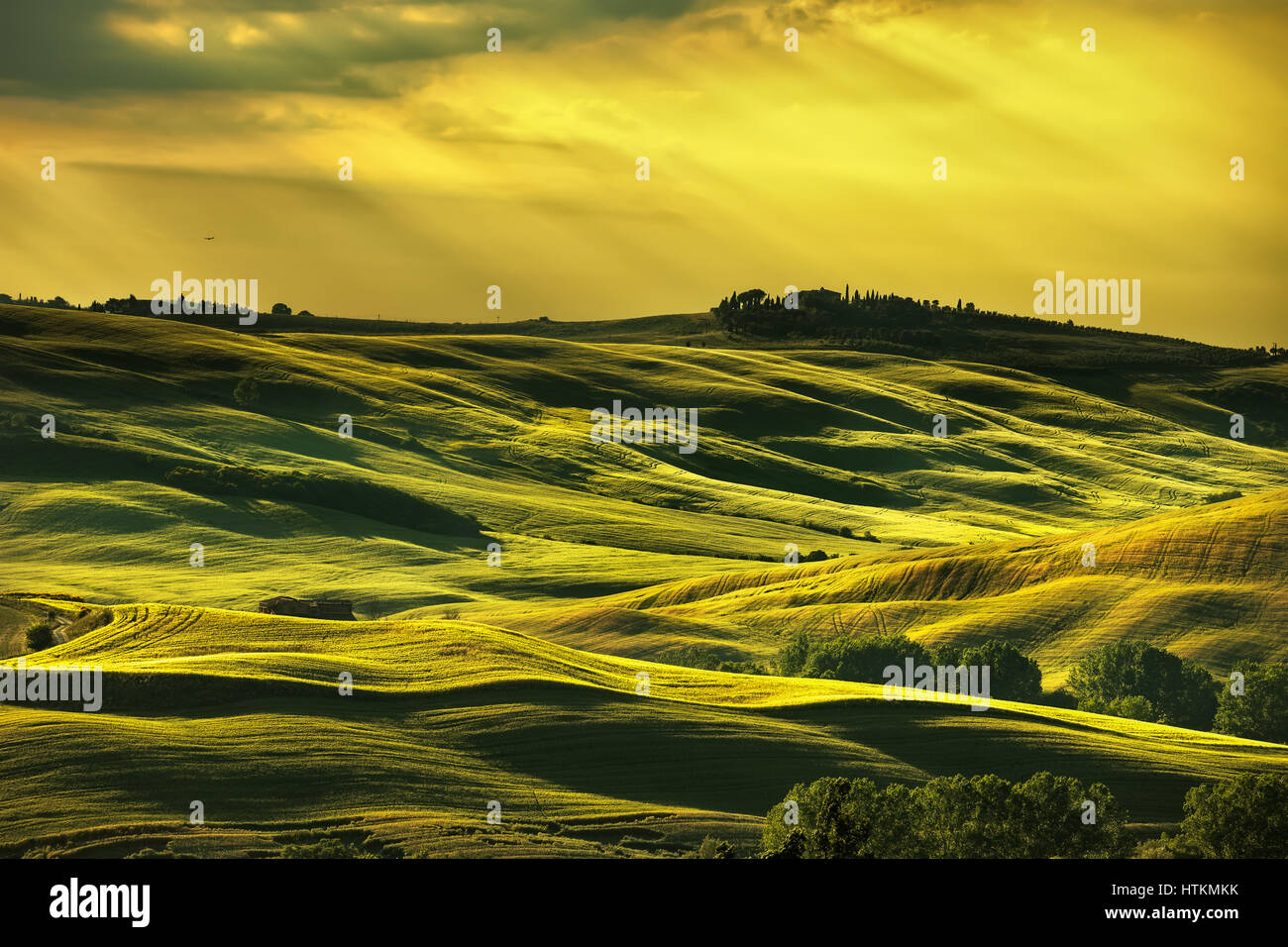 Tuscany spring, rolling hills on sunset. Rural landscape. Green fields and farmlands. Italy, Europe Stock Photo