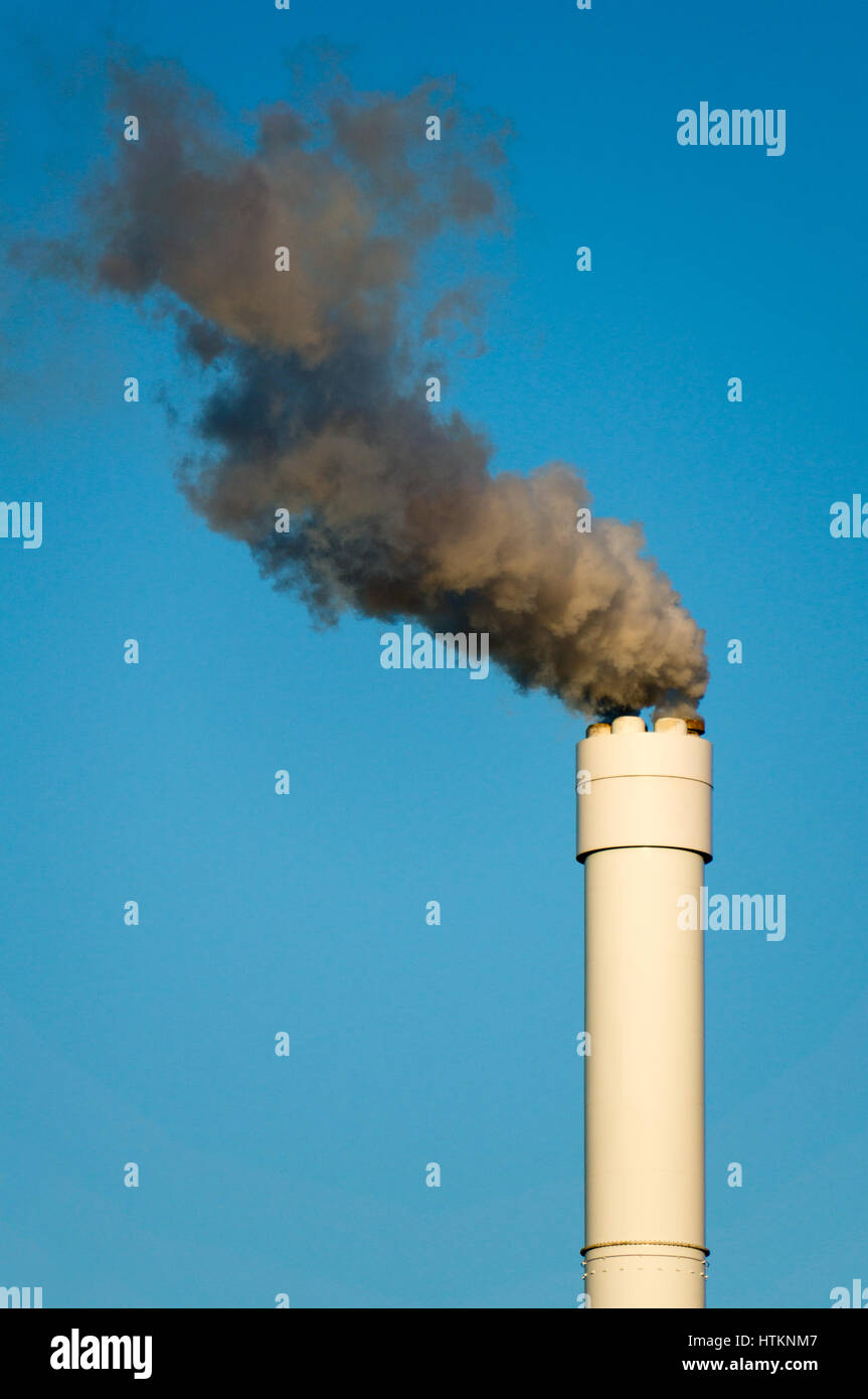 Smoke coming from a chimney, rising against a clear nice blue sky Stock ...