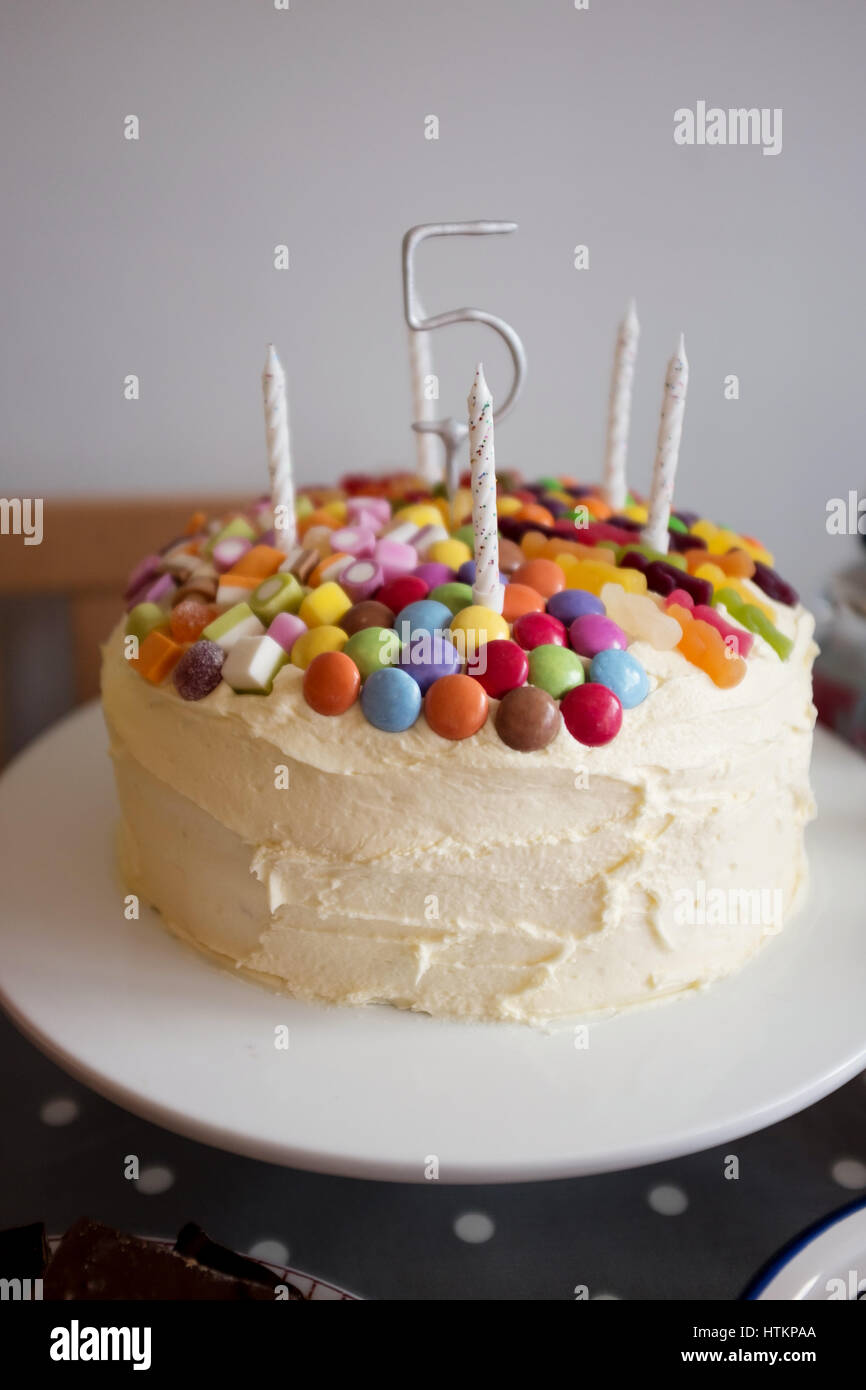 Children's birthday cake with five candles and the number five. Stock Photo