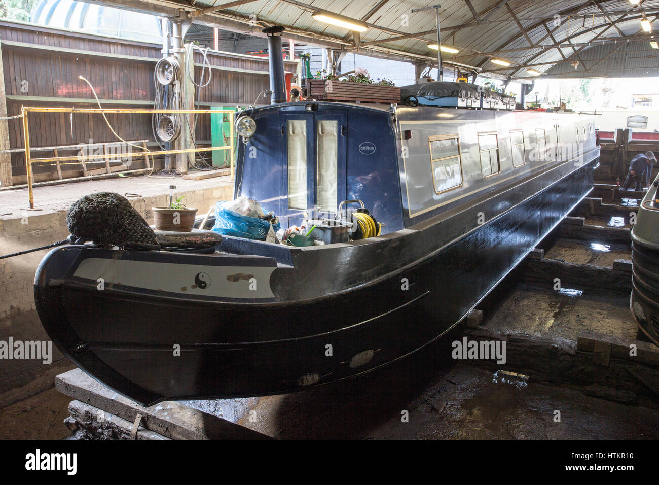 Narrow boat in dry dock for blacking Stock Photo