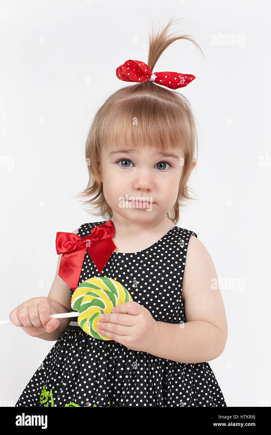 The little girl holds big beautiful lollipop Stock Photo