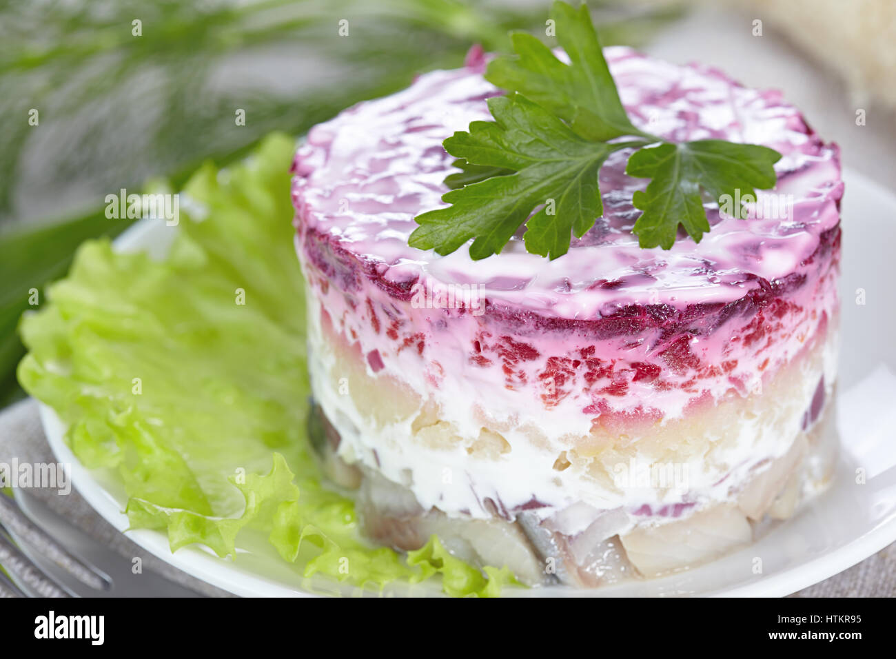 Salad 'Herring under a fur coat'on a white plate Stock Photo