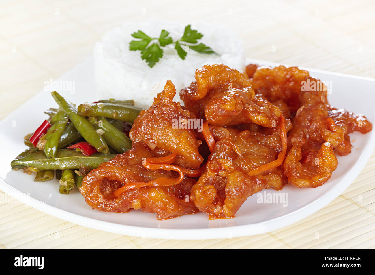 Chinese cuisine. Pork in batter and sweet and sour sauce with green beans in Sichuan Stock Photo