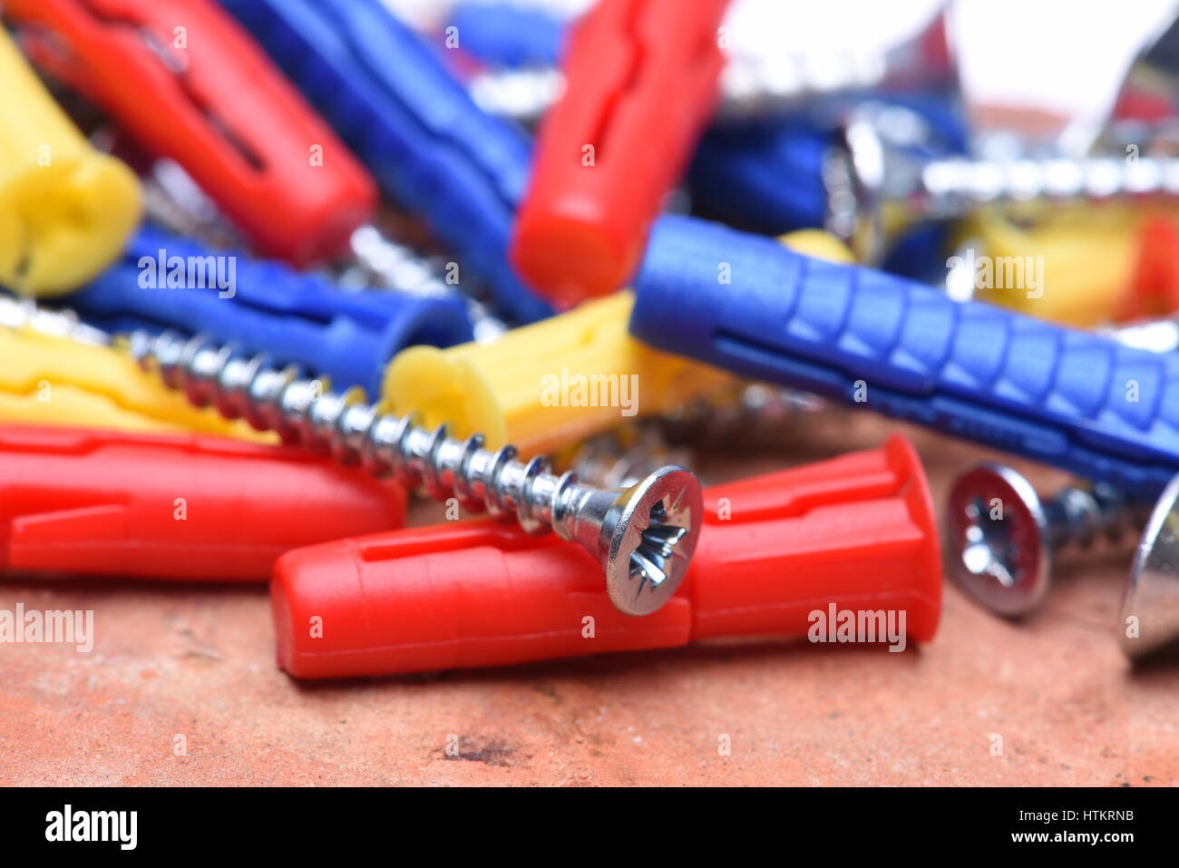 Plastic Dowels ans Screws on Red Brick Background Stock Photo Alamy