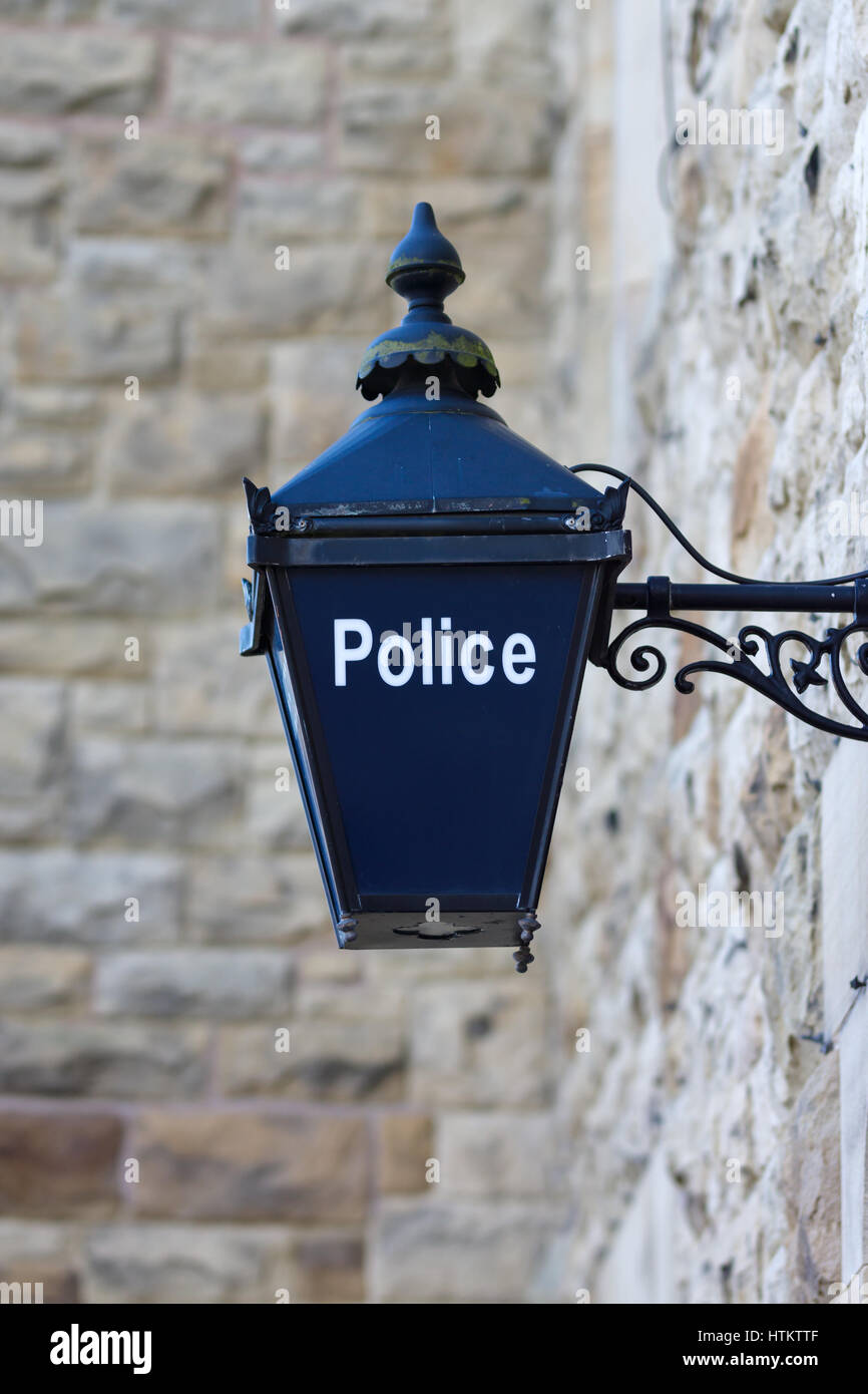 Old fashioned illuminated blue lamp outside a British police station traditonally used since Victorian times Stock Photo