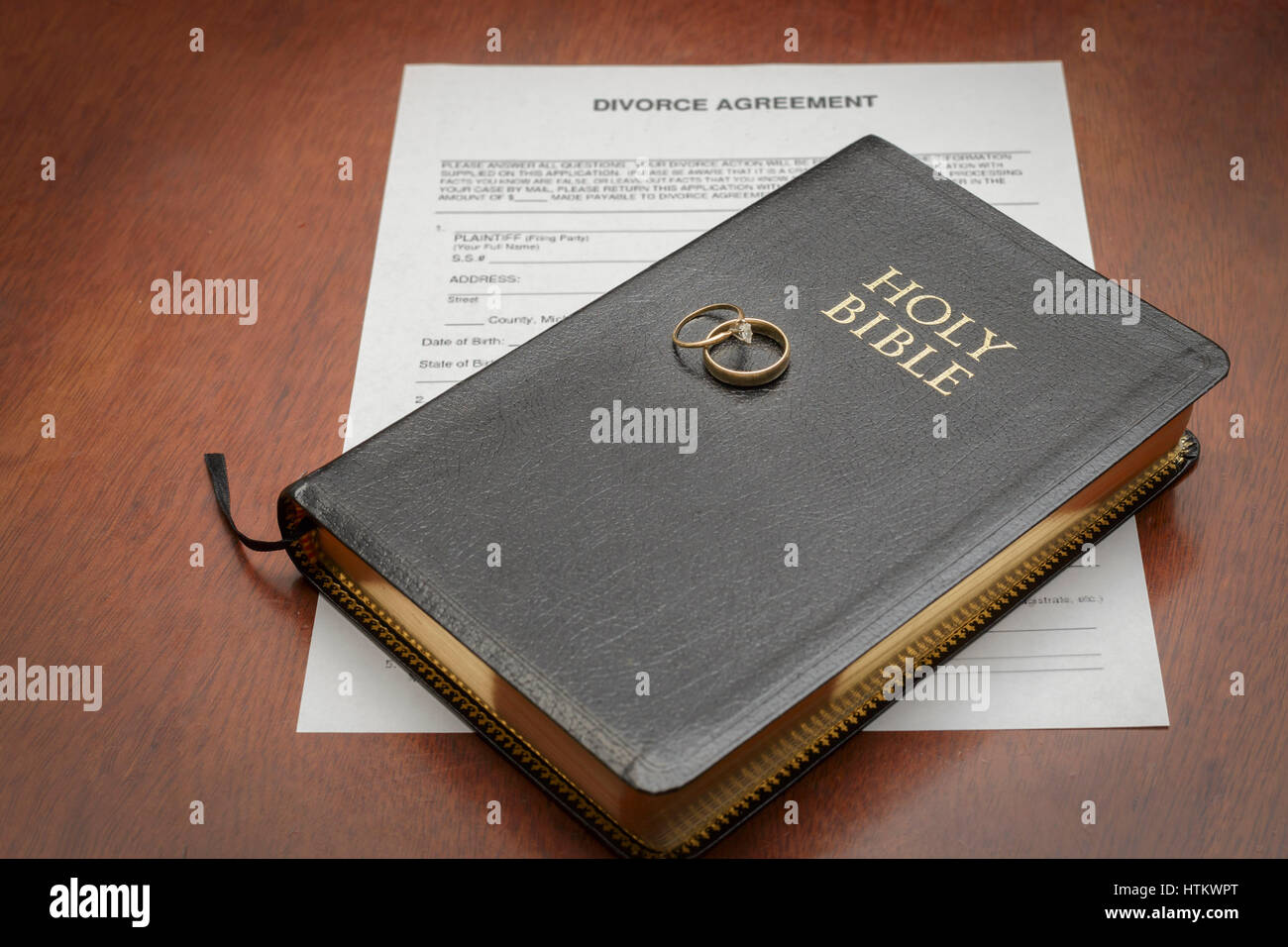 wedding rings and bible with divorce papers Stock Photo