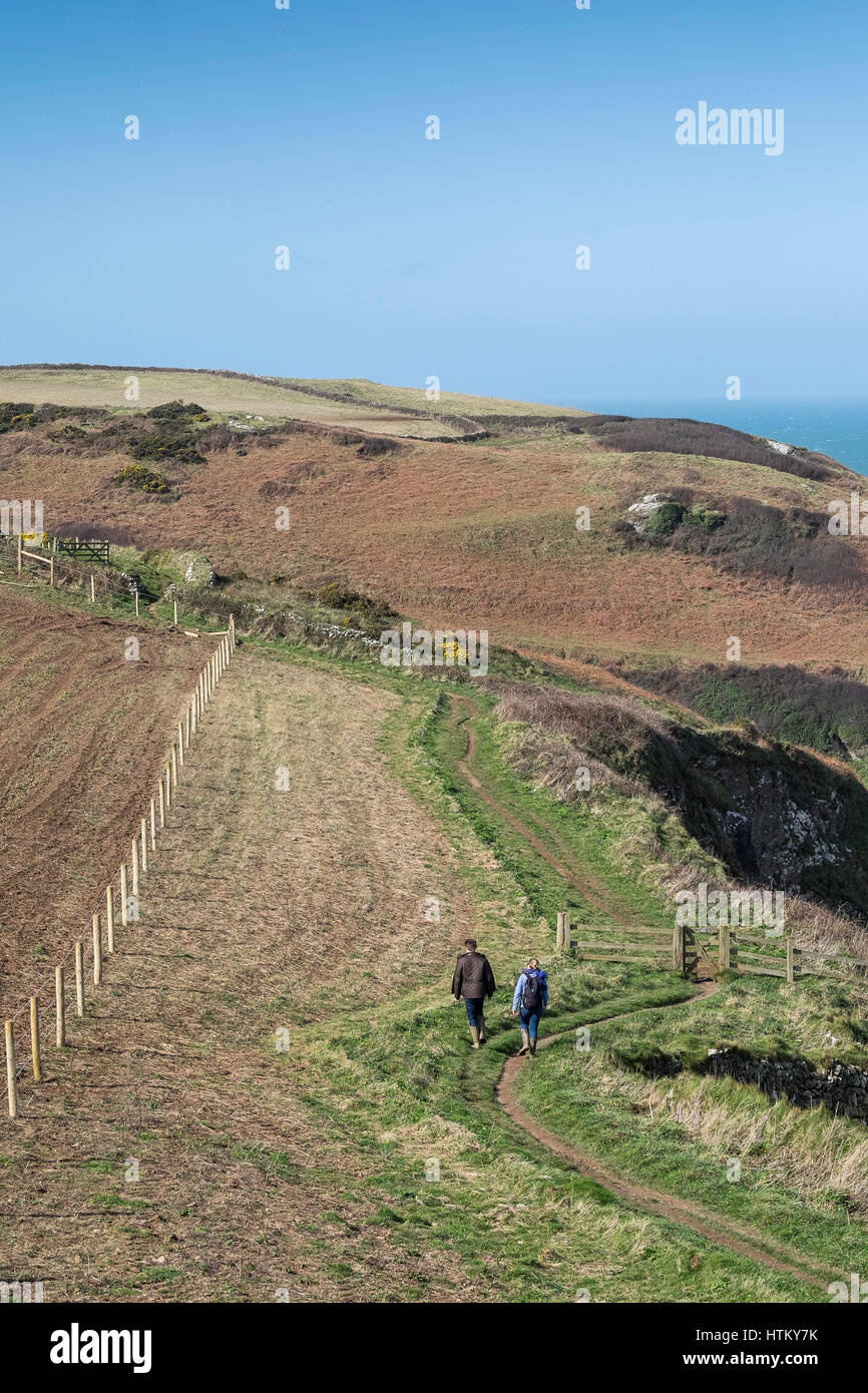 Two walkers South West Coastal Path Pentire Headland Cornwall Stock Photo