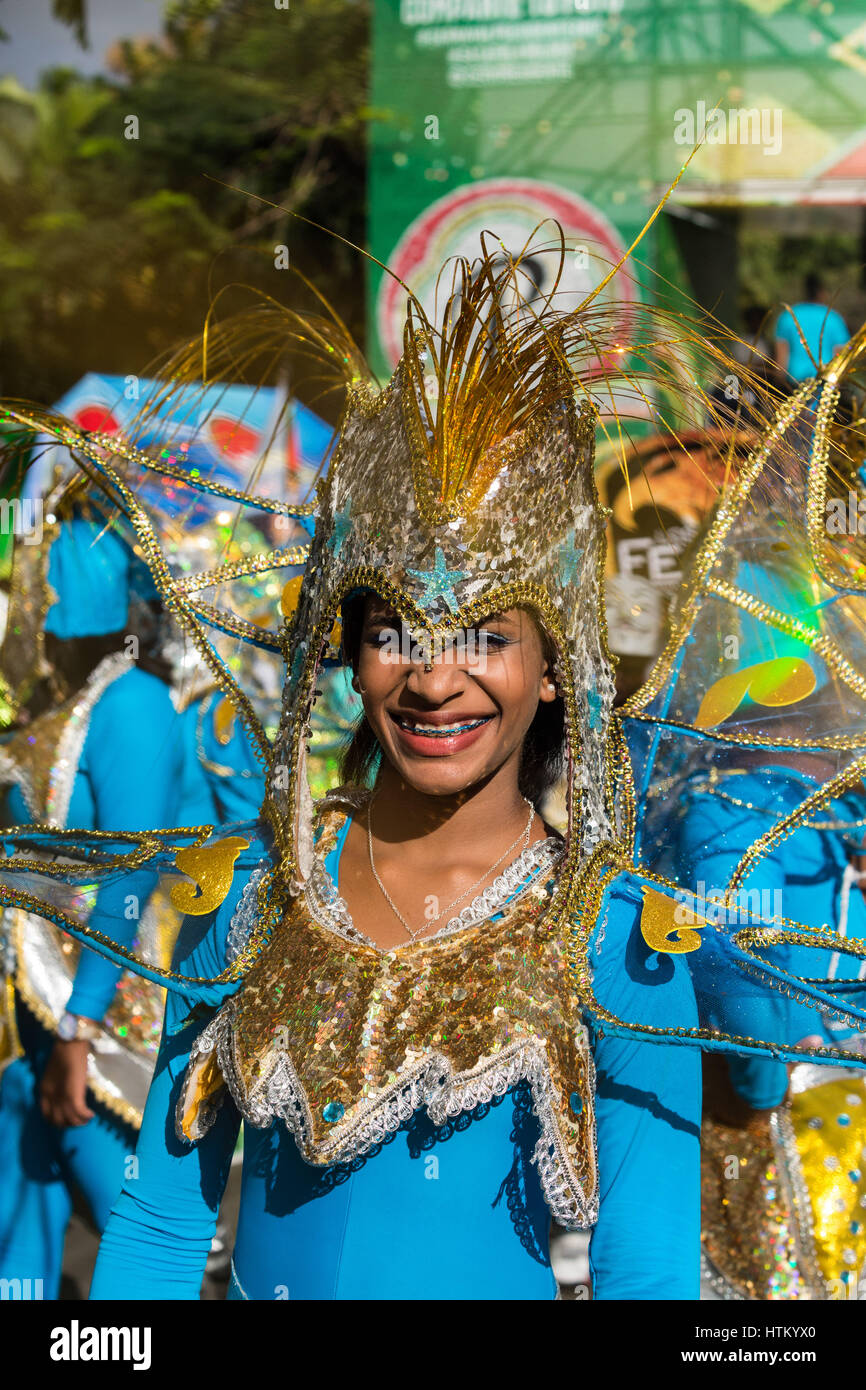 Costumed woman marches in the La Vega Carnival parade. The first ...