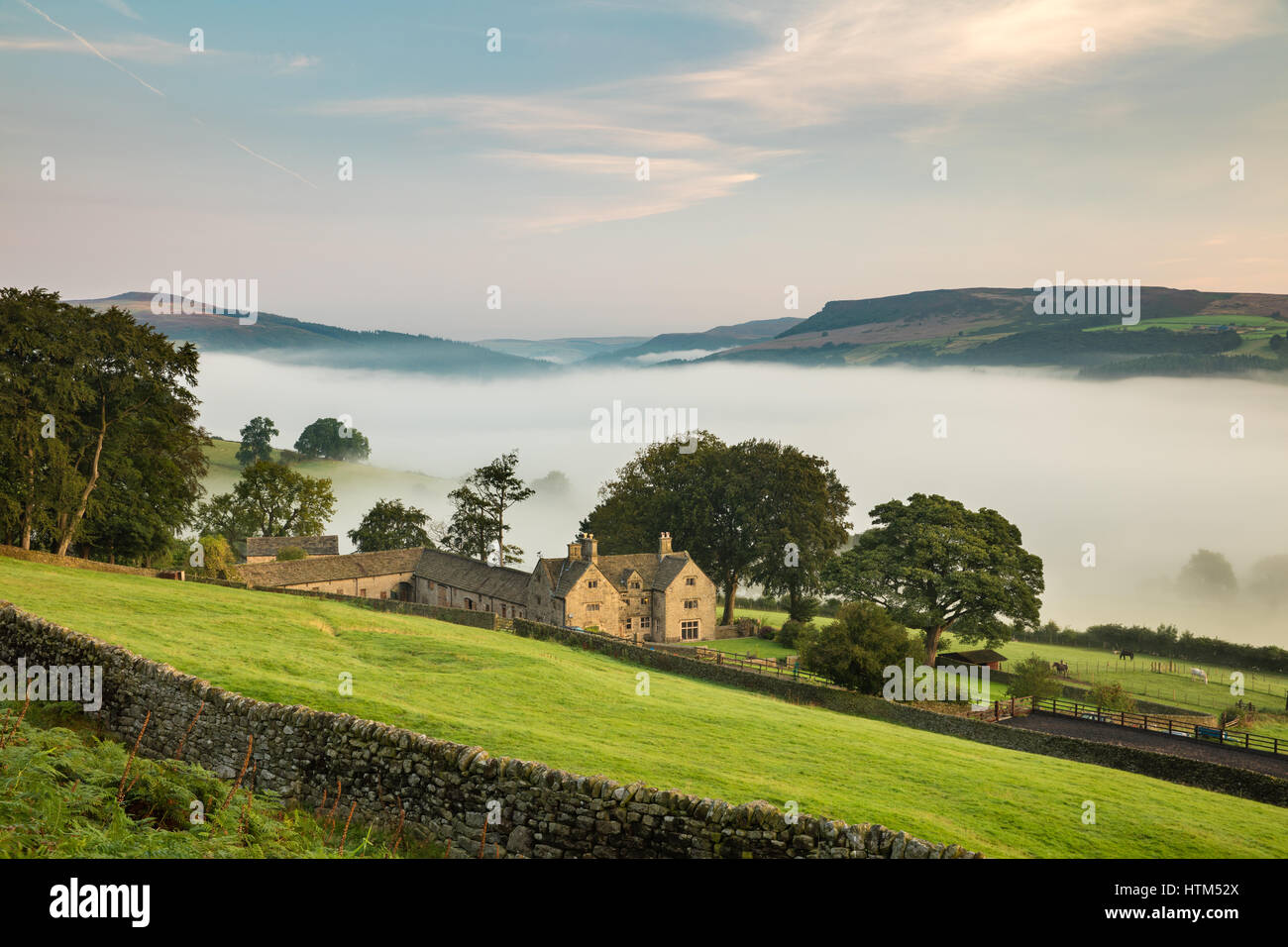 Offerton Hall above the mist in the Derwent Valley below, Derbyshire Peaks District, England, UK Stock Photo