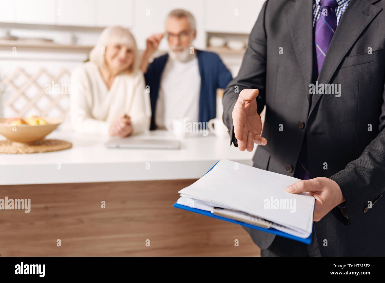 Credible social security advisor demonstrating document for elderly couple Stock Photo