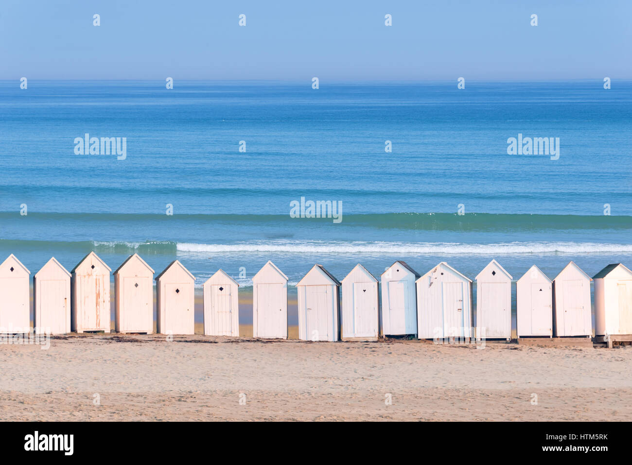 Line Of White Beach Cabins Ocean In The Background France Stock