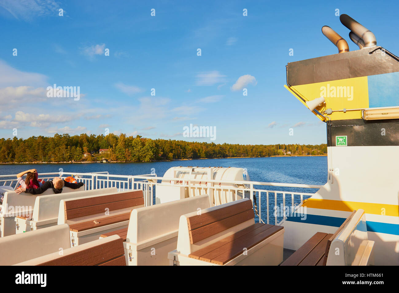 Passengers sitting on outer deck of ferry sailing in the Stockholm archipelago, Sweden, Scandinavia Stock Photo