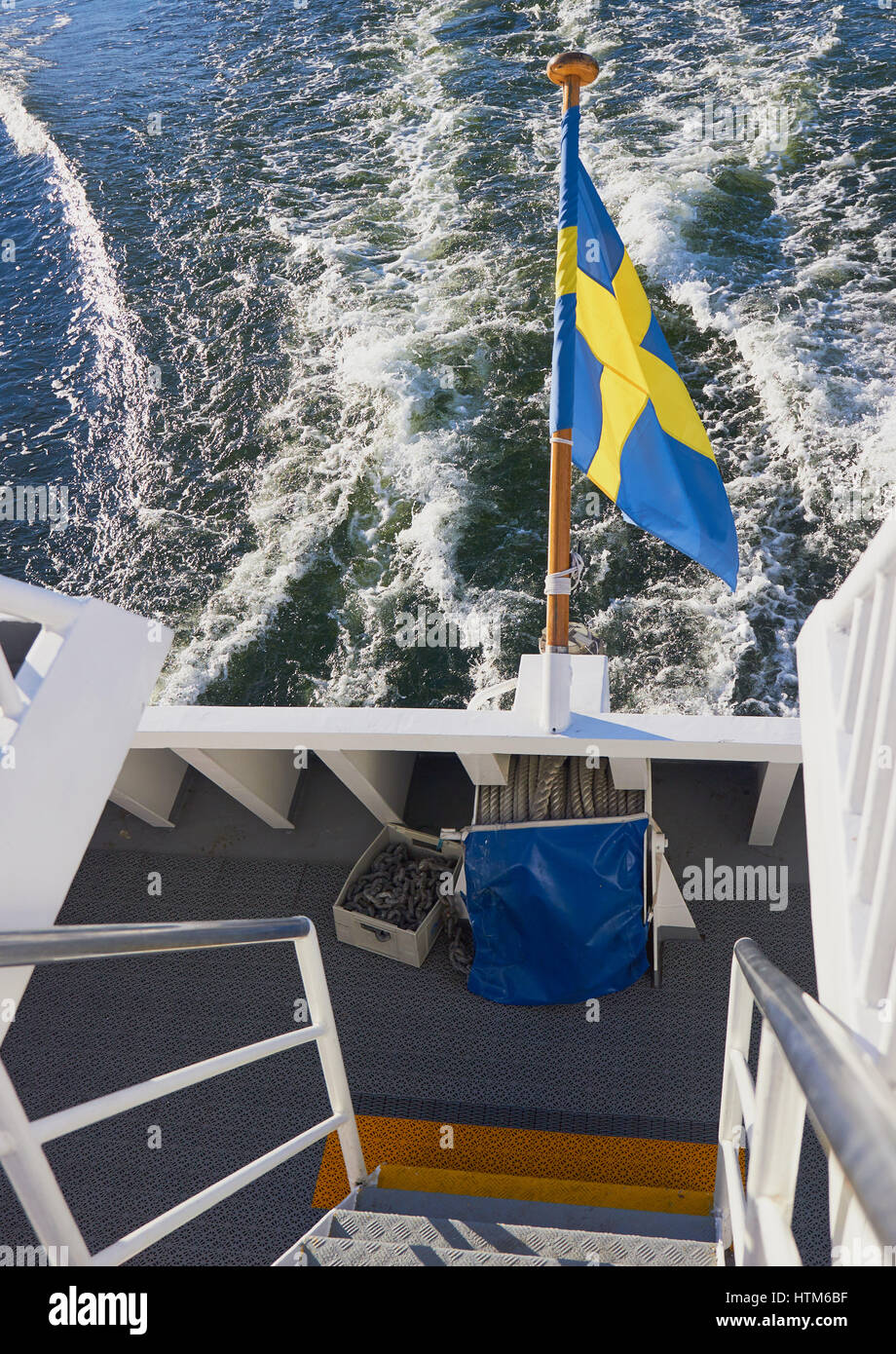 Swedish flag flying from speeding boat, Sweden, Scandinavia Stock Photo