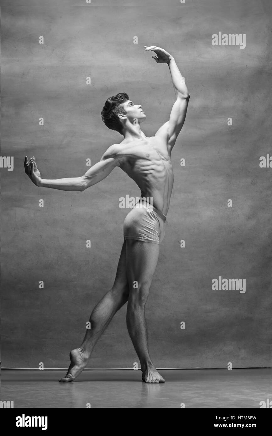 male ballet dancer posing over gray Stock Photo Alamy