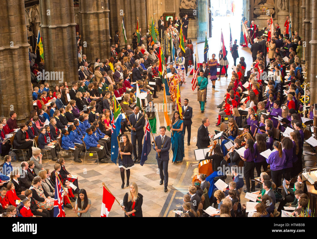Flag bearers carry the flags of the commonwealth nations during the Commonwealth Service at Westminster Abbey, London. Stock Photo