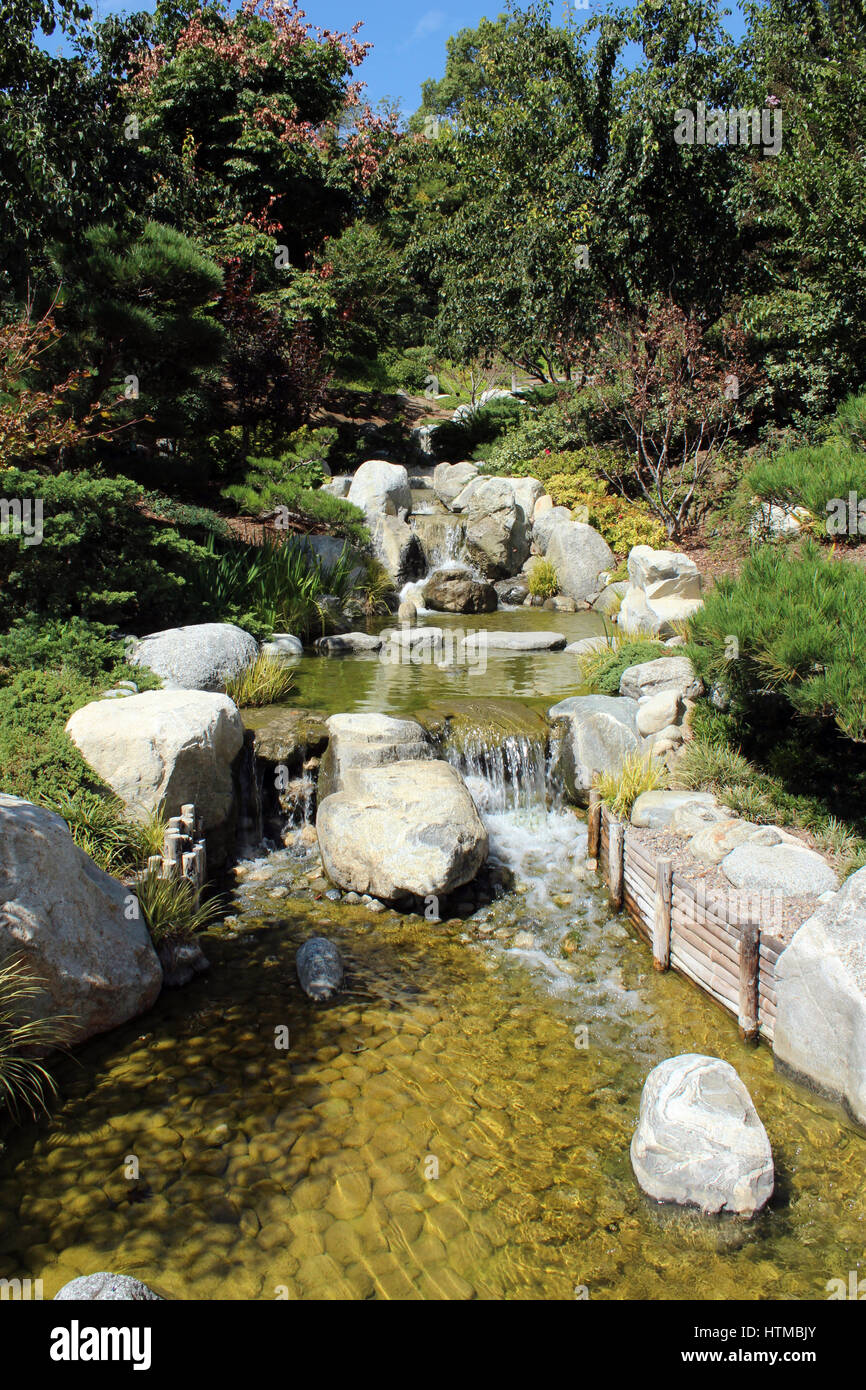 Beautiful stream with small rocky waterfalls in a garden setting Stock ...