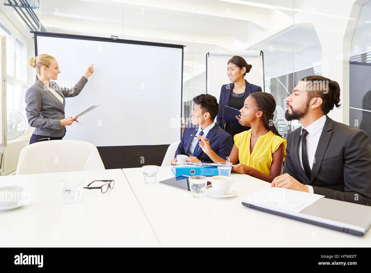 Businesswoman gives presentation with flipchart in business seminar Stock Photo