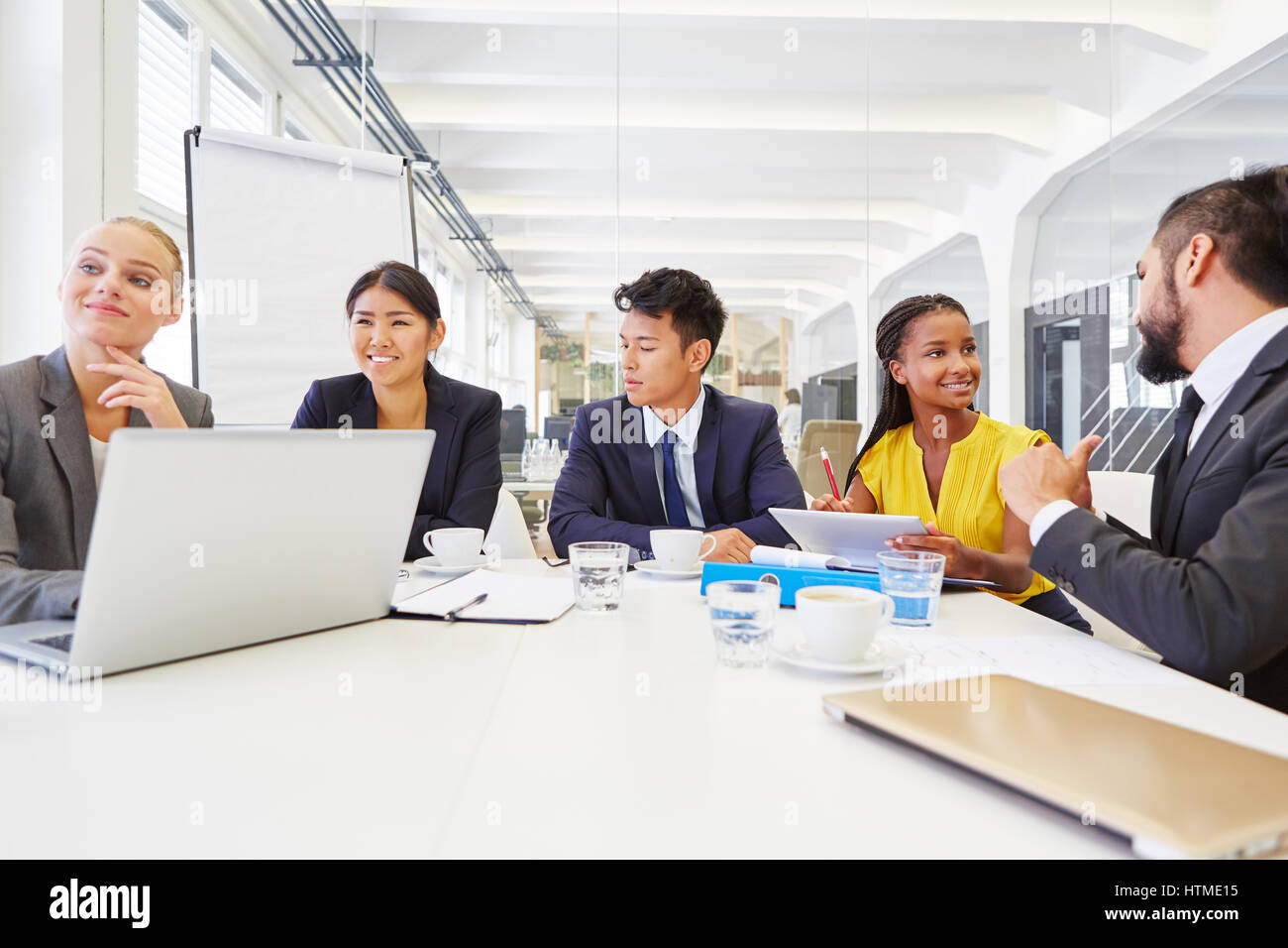 Interracial team working together in business meeting Stock Photo