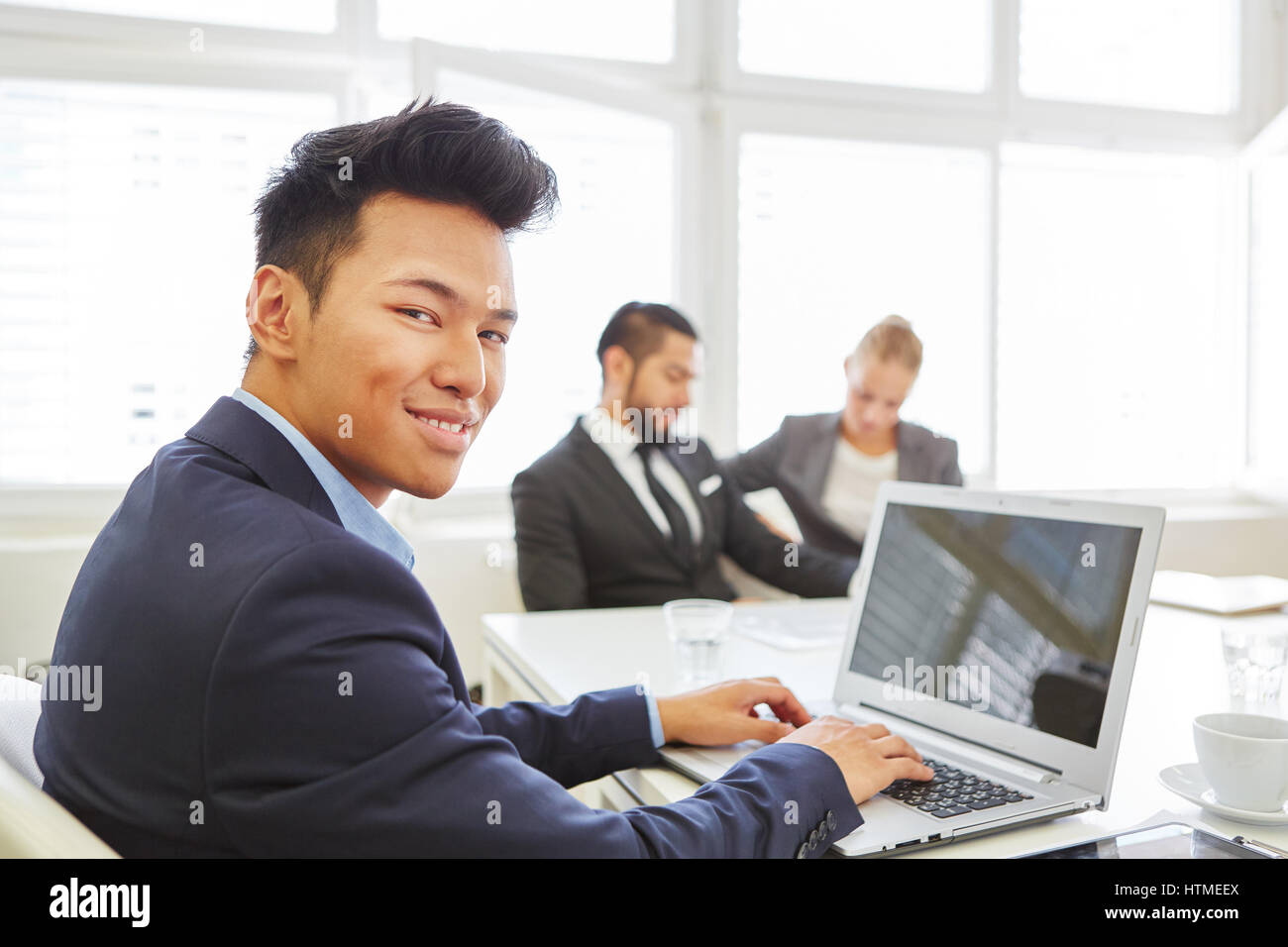 Asian man as computer scientist and programmer working with laptop Stock Photo