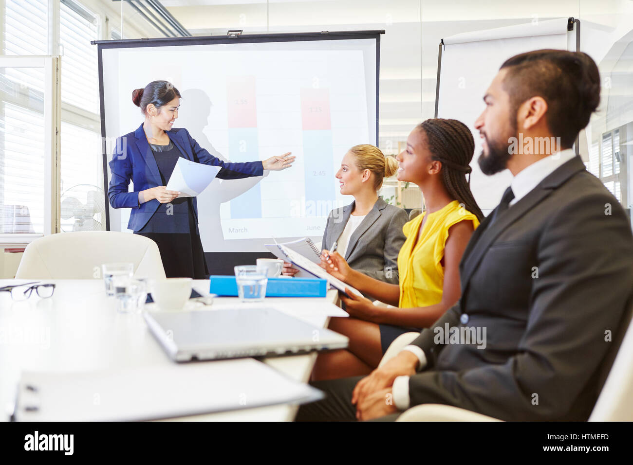 Lecturer giving presentation in business seminar with flip chart and whiteboard Stock Photo