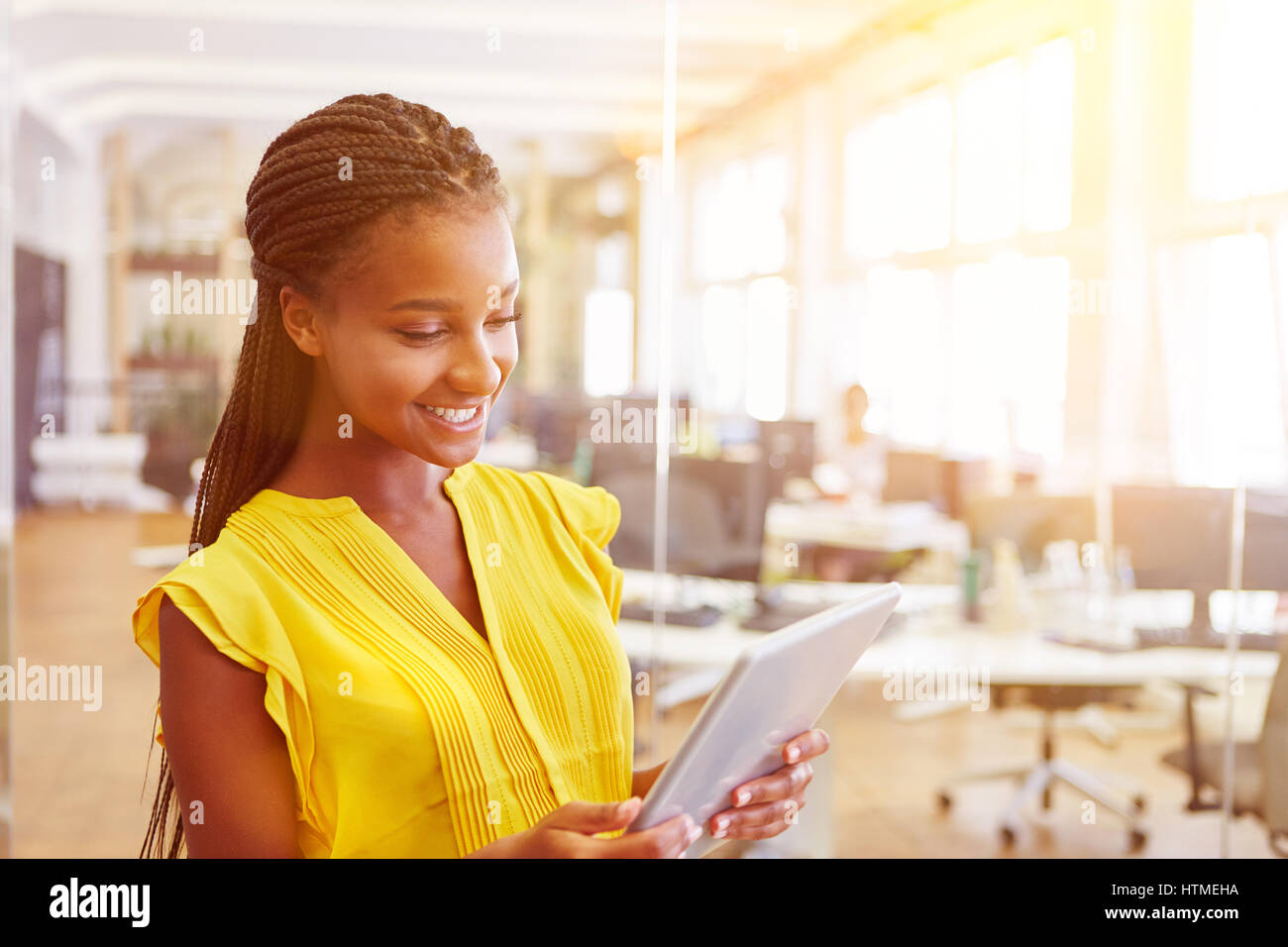 Young african woman with tablet computer surfing the internet Stock Photo