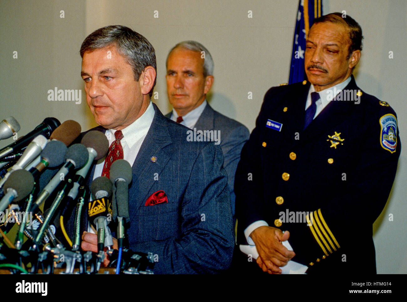 FBI Assistant Director Anthony Daniels answers reporters questions during a news conference held at the FBI's Washington DC field office late in the evening to describe the events earlier in the day when 2 FBI agents and a police officer were killed in DC police headquarters, DC Police Chief Fred Thomas stands behind Daniels Washington DC., November 22, 1994. Photo By Mark Reinstein Stock Photo