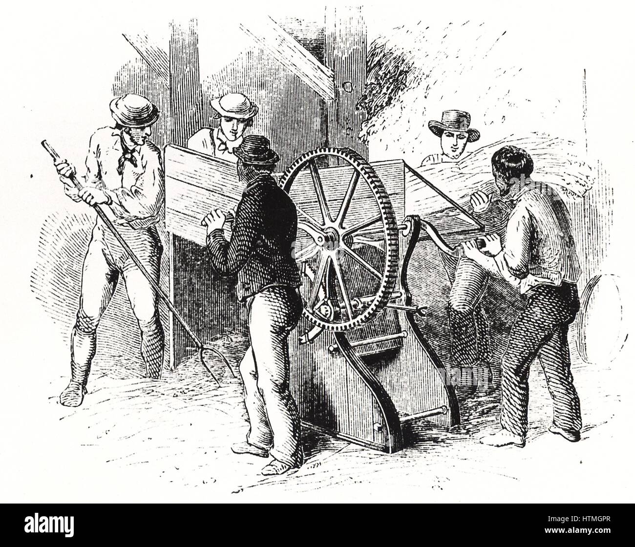 Hand-powered threshing machine by Barrett, Exall & Andrews. These machines were more efficient than the traditional threshing with flails, the labour-intensive winter occupation of farm labourers. Engraving c1850. Stock Photo