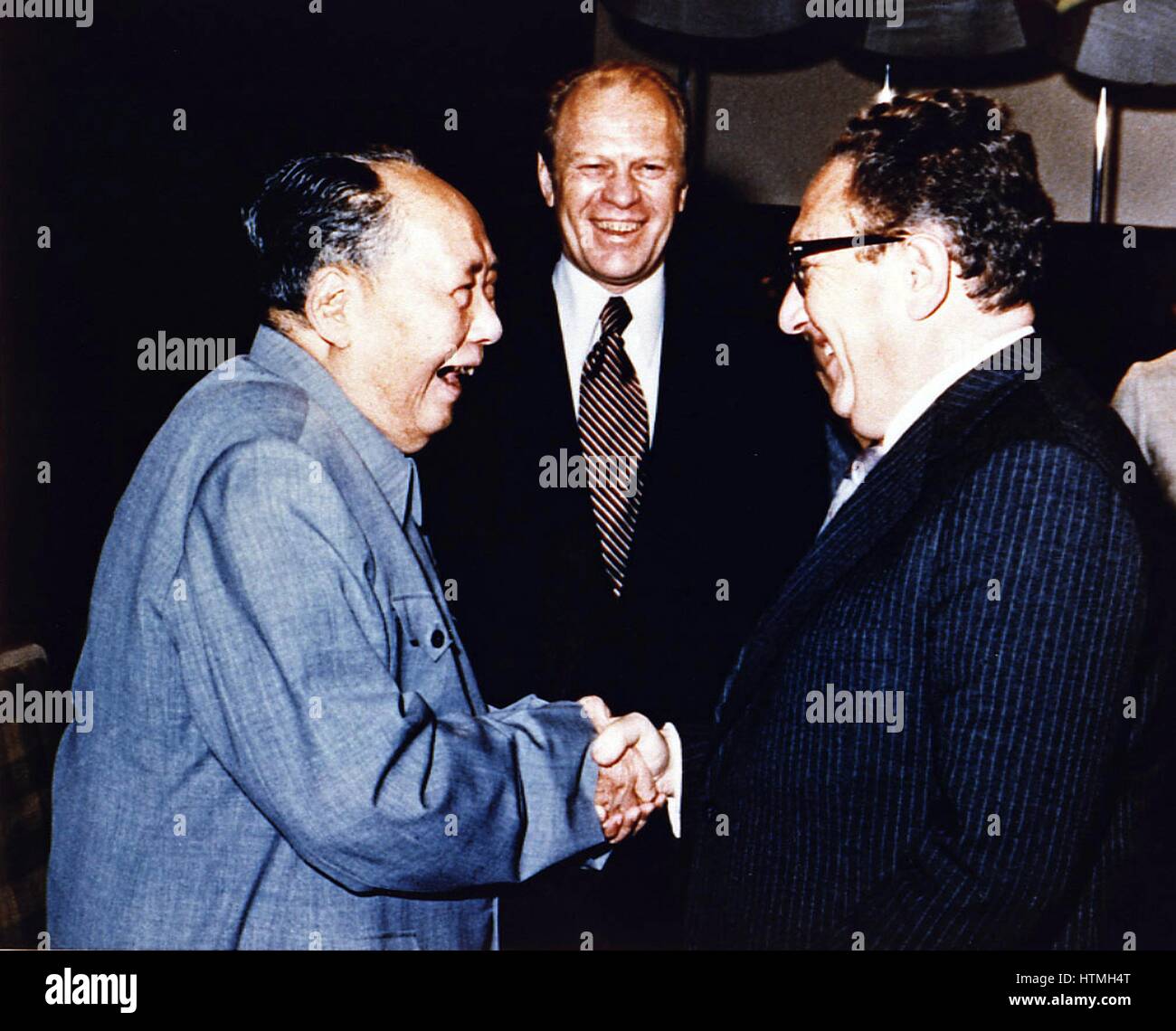 Copy of President Ford Secretary of State Henry Kissinger with Mao Tse-Tung; Chairman of Chinese Communist Party, during a visit to the Chairman’s residence Stock Photo