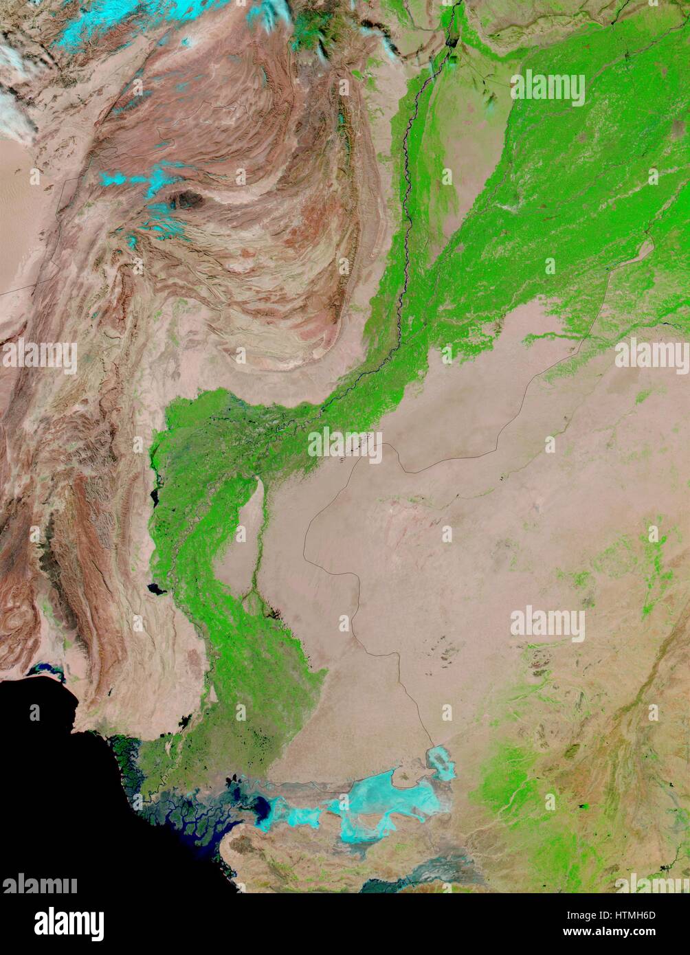 false-colour images feature the Indus River Valley, a lush oasis of vegetation made possible by the Indus River, which is visible as a thin black thread heading toward the Arabian Sea in the false-colour image. Stock Photo