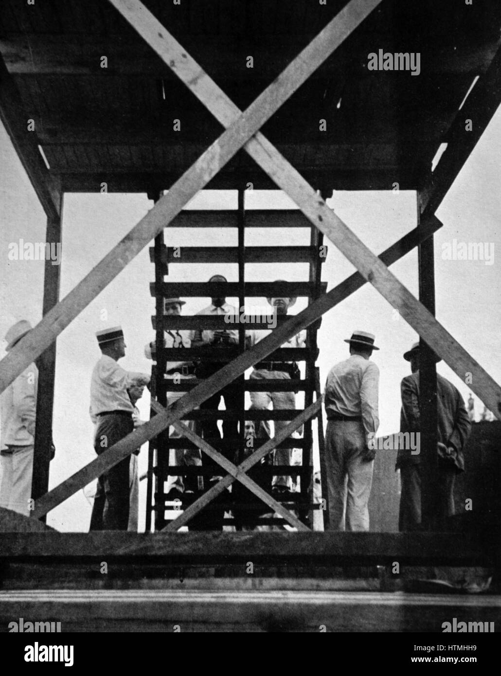 A public hanging in Kentucky, U.S.A. A twenty-two year old black man convicted of the assault and murder of an old woman is led up the gallows steps. Stock Photo