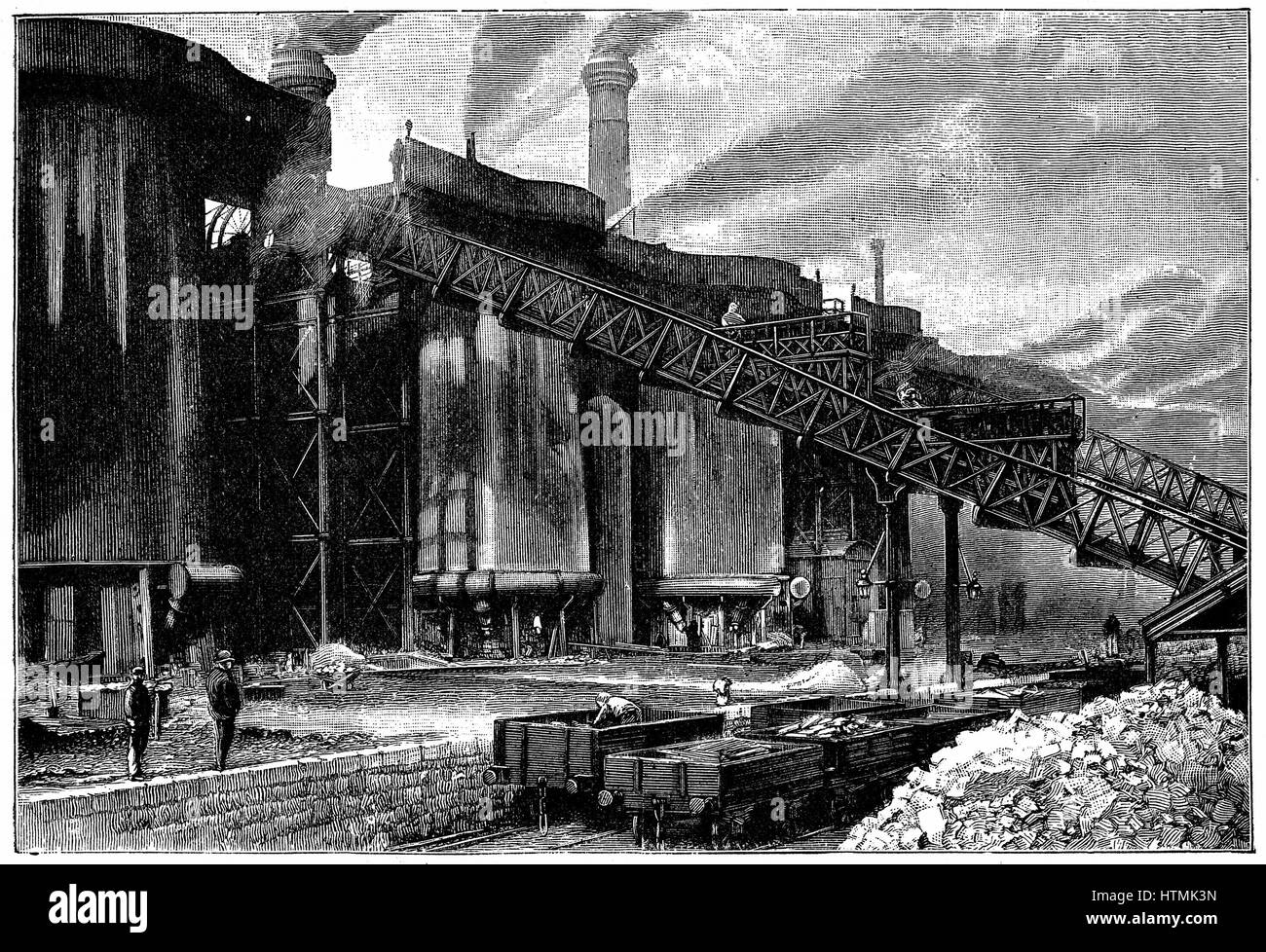 Blast furnaces, Barrow Haematite Iron and Steel Company, Barrow in Furness, Lancashire (Cumbria). Charge being taken to top of furnace on railway. In foreground are railway trucks transporting ore and fuel. Wood engraving 1890 Stock Photo